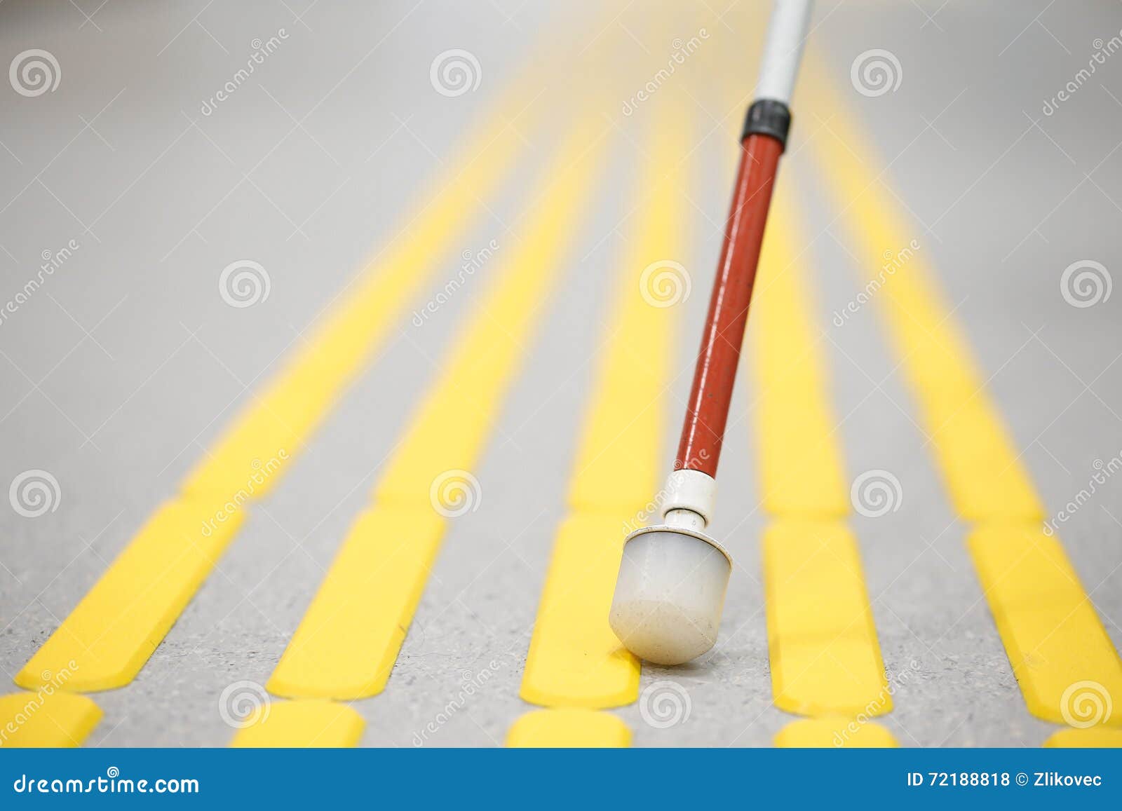 blind pedestrian walking on tactile paving