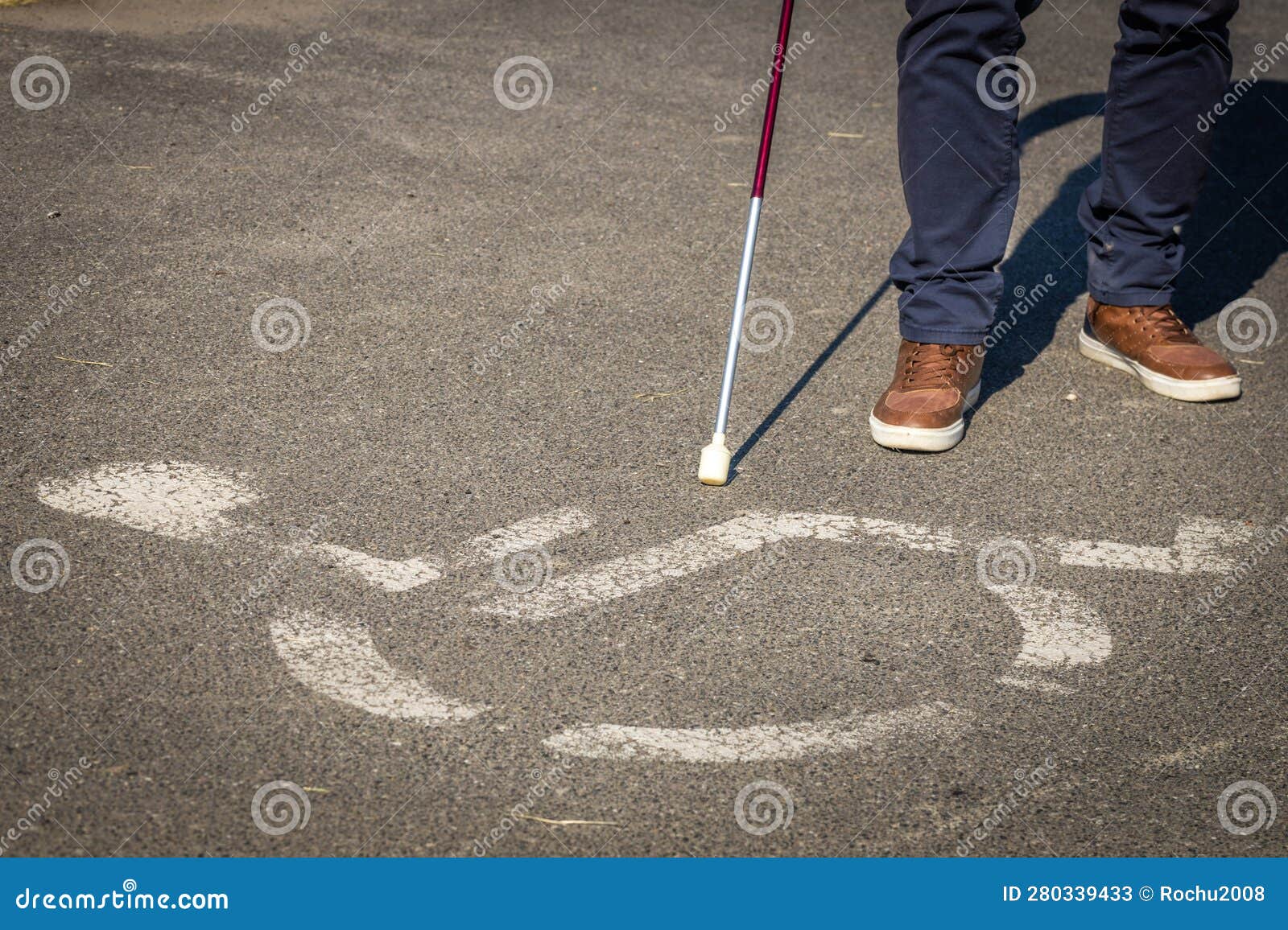 Blind Person with a Cane Walking in Front of a Horizontal Sign for