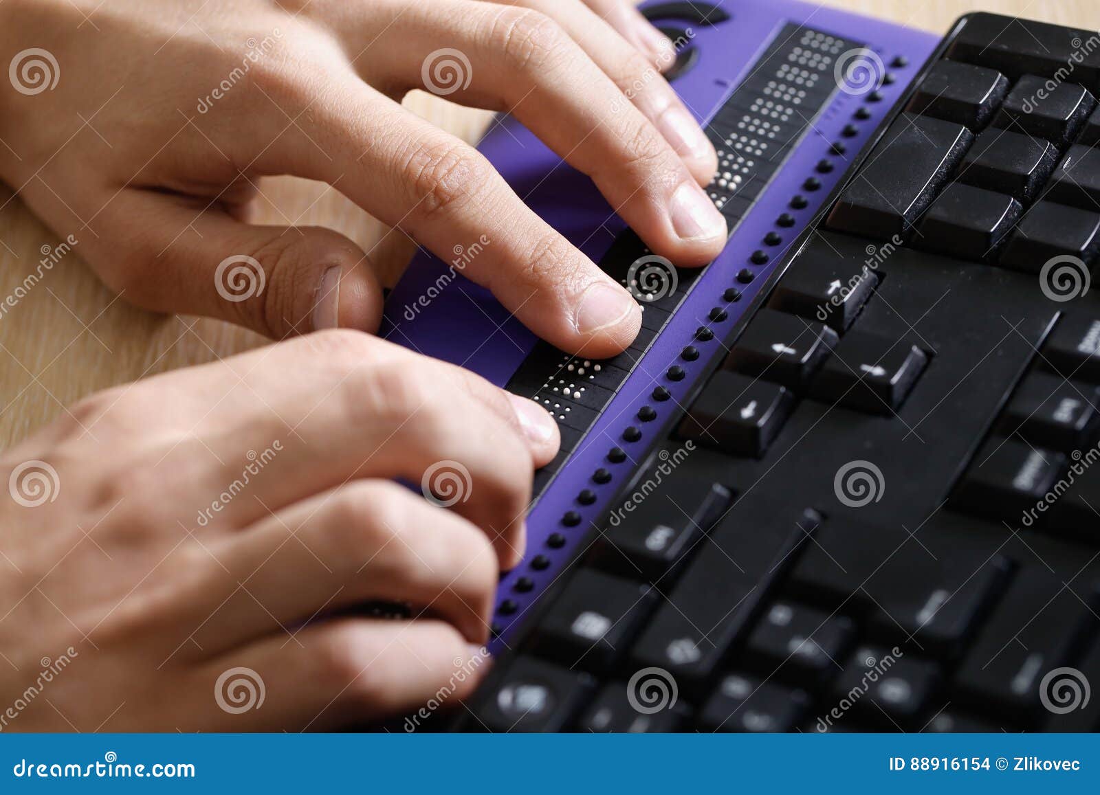 blind person using computer with braille computer display