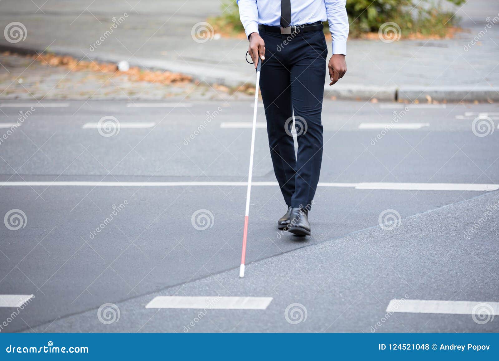 blind person walking on street