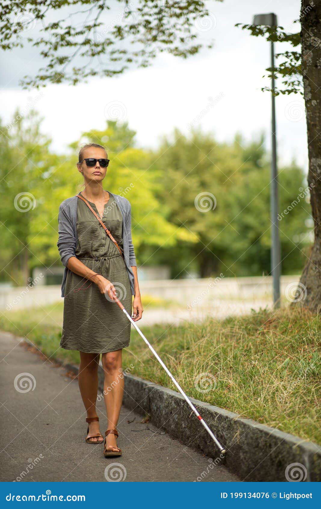 Blind Woman Walking on City Streets, Using Her White Cane Stock