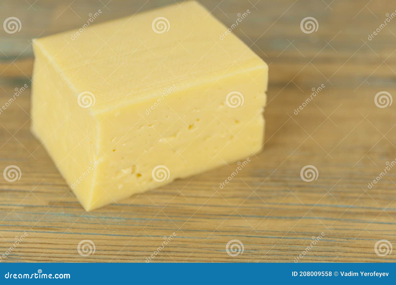 Block Of Cheese On Shredded Cheddar Cheese Background Stock Photography