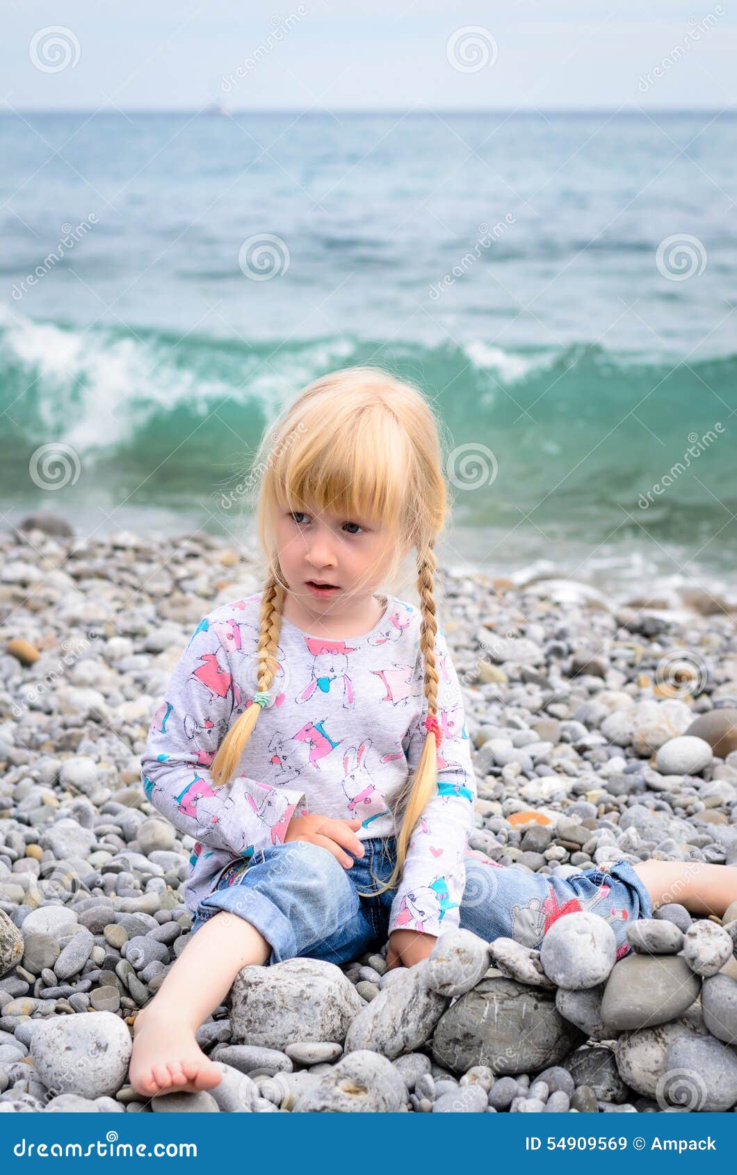 Blond Girl Building Stone Wall on Rocky Beach Stock Image - Image of ...