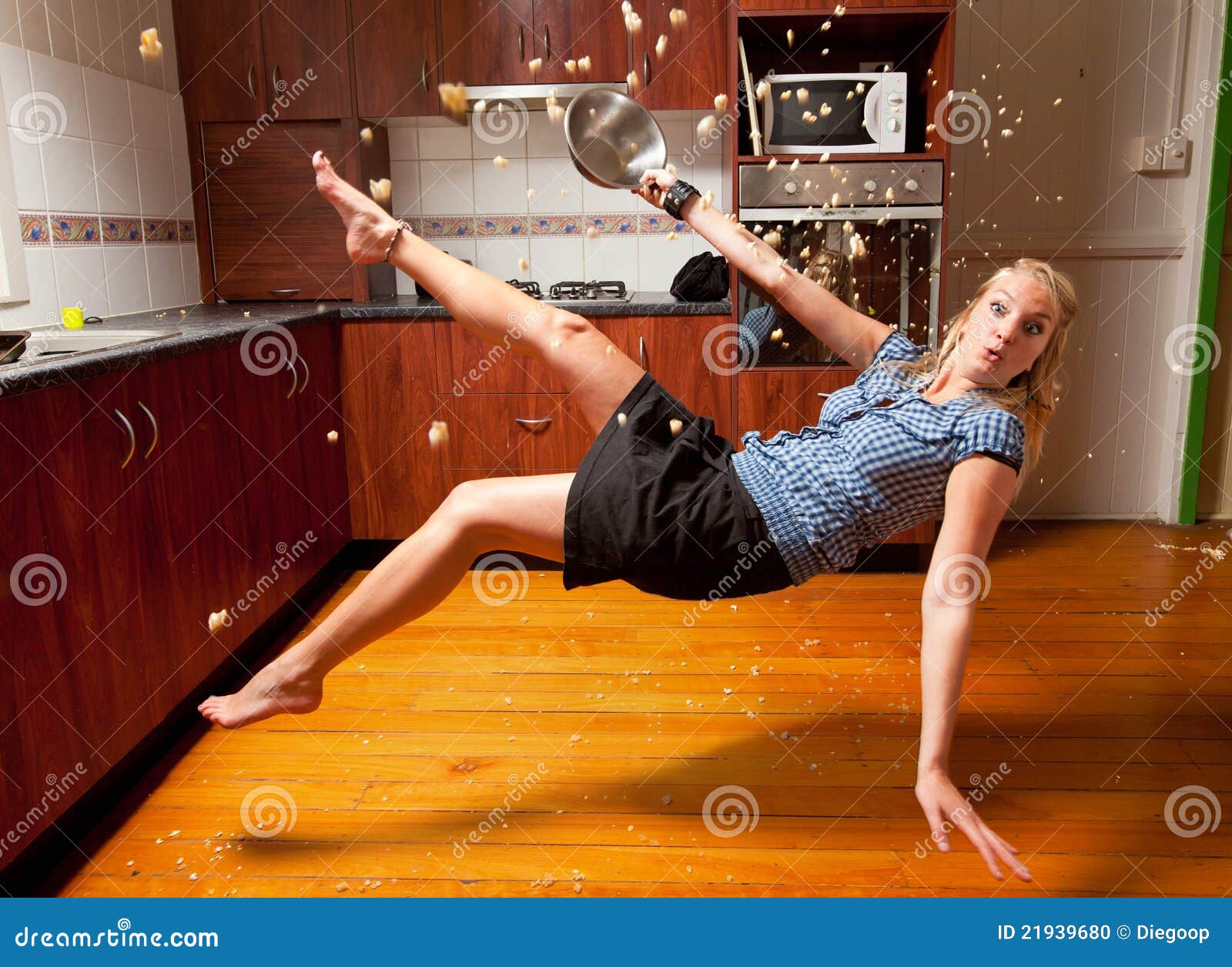 Blond Girl Falling In The Kitchen Stock Photo - Image: 21939680