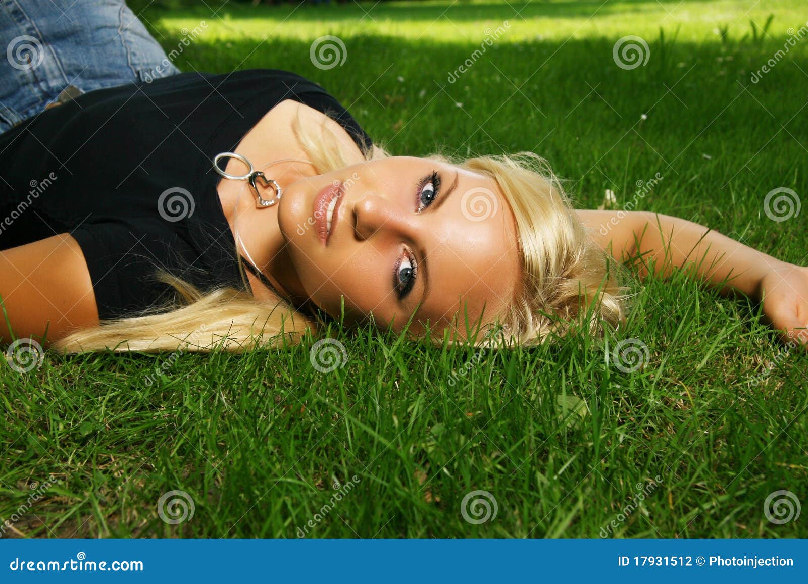 3 pretty blonde girls frolicking on the grass