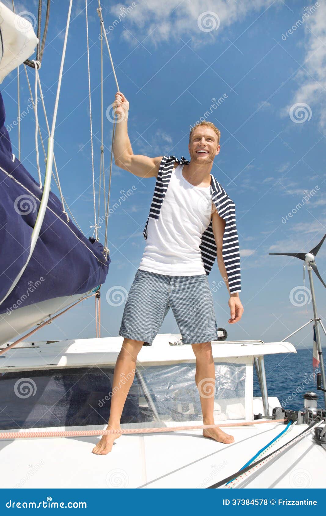 Blond Handsome Young Man On Sailing Boat. Stock Photo 