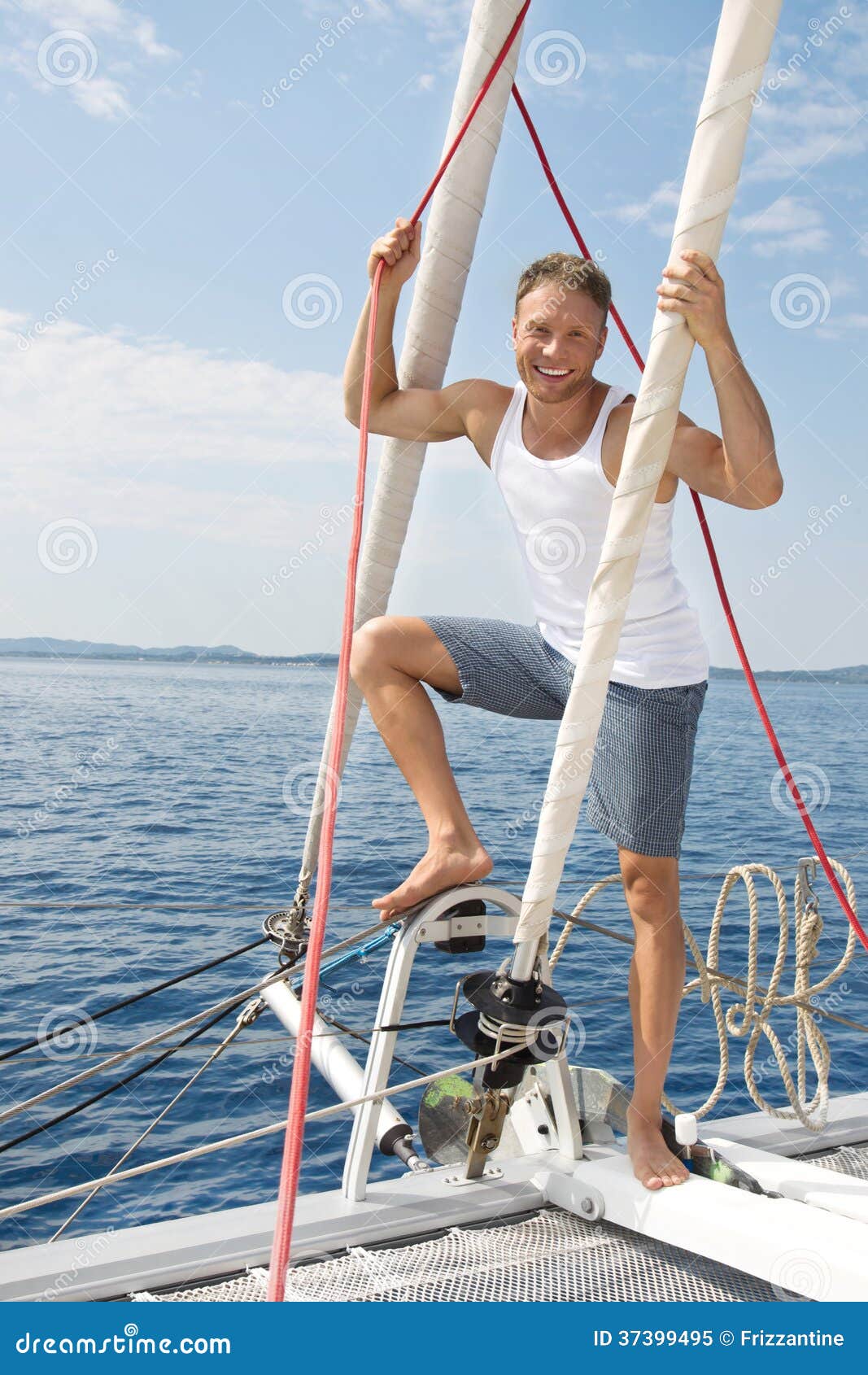 blond handsome young man on sailing boat. royalty free