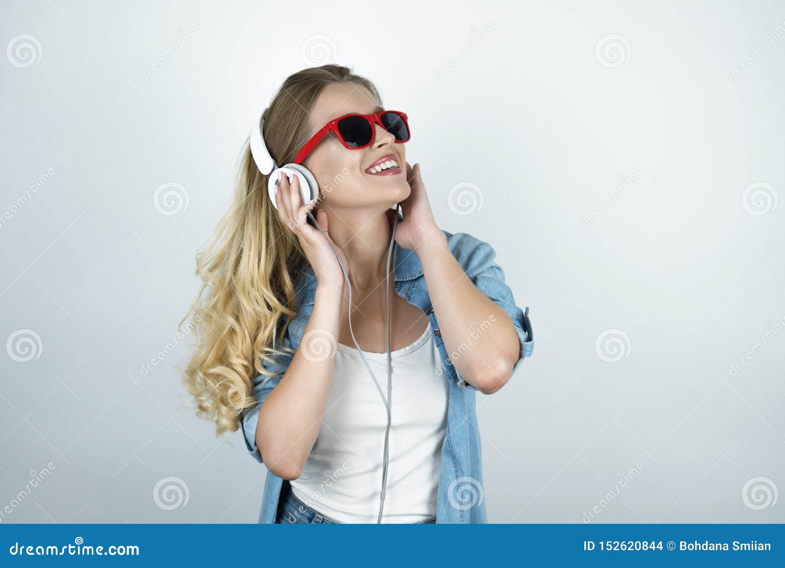 Blond Woman In Headphones And Sunglasses Listening To Music Smiling White Isolated Background