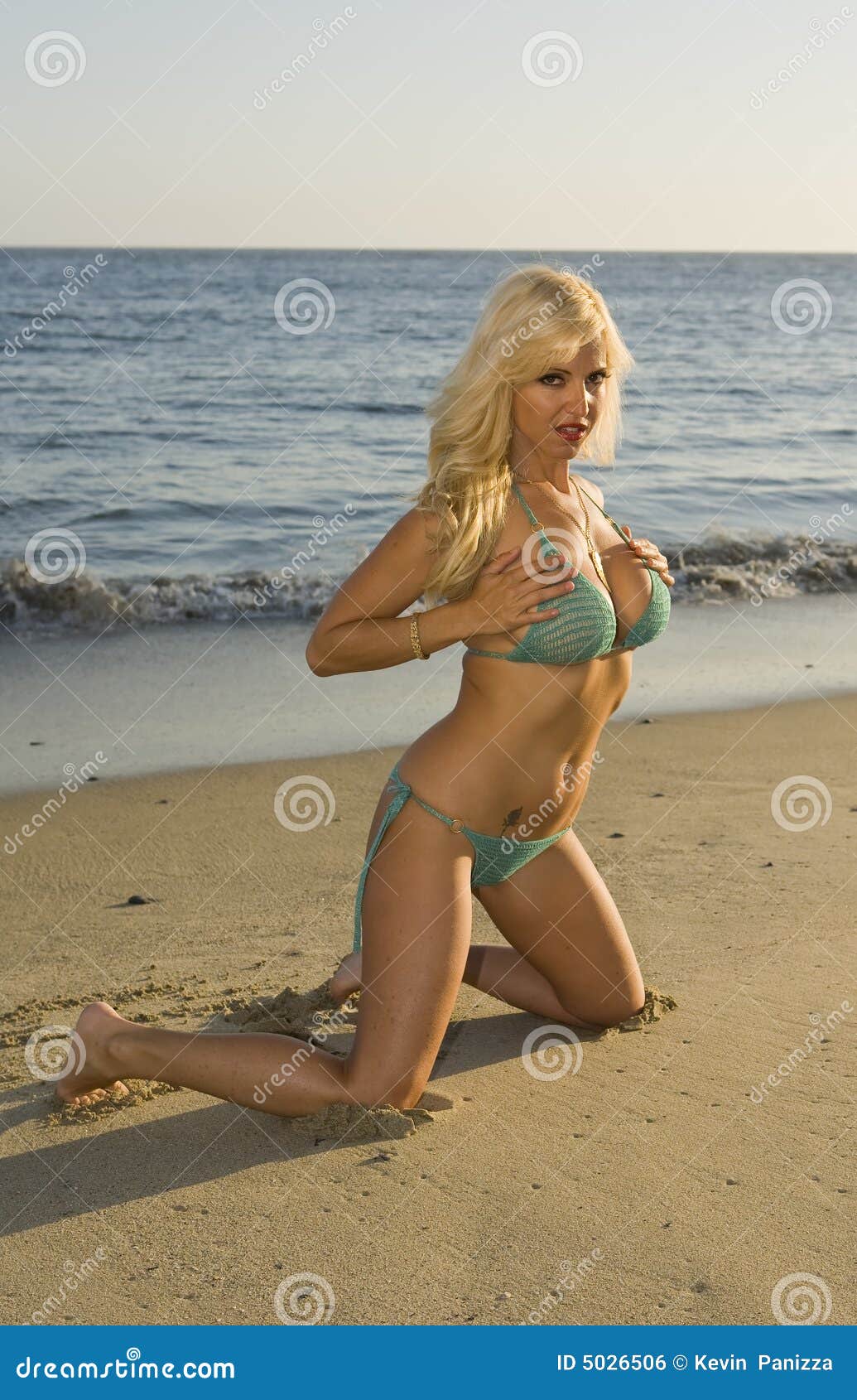 Blond Woman Holding Her Breasts on the Beach Stock Photo - Image of blue,  orange: 5026506