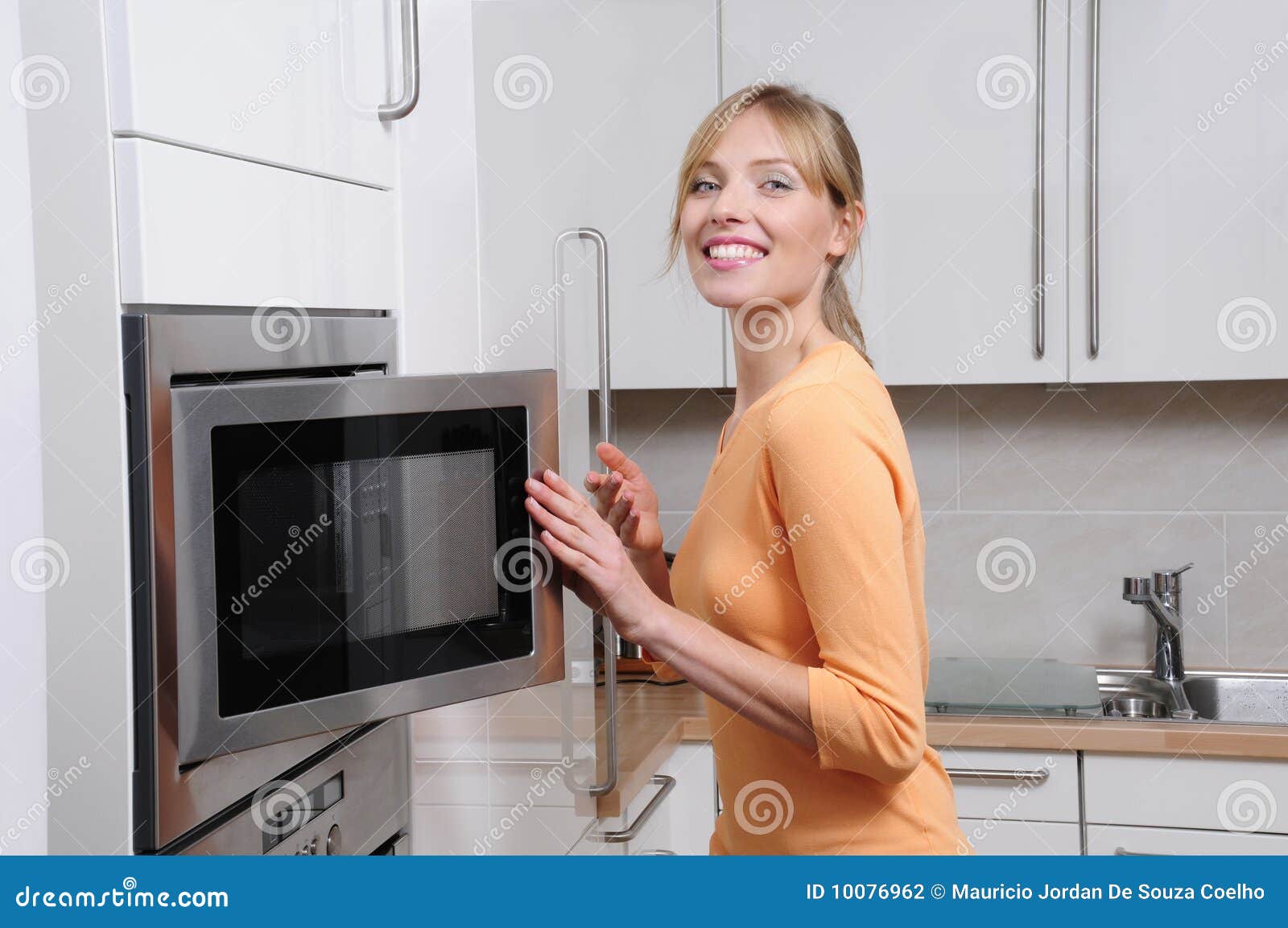 blond woman with a microwave