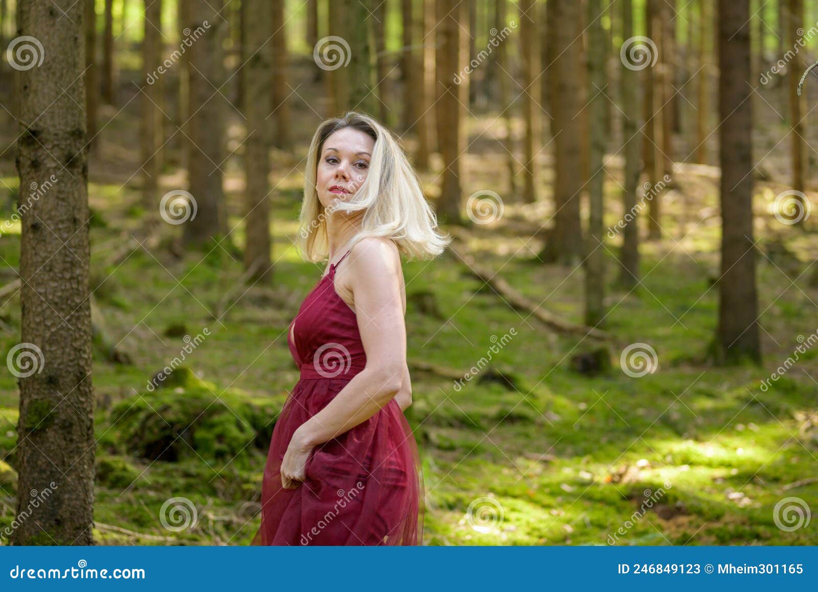Blond Woman Turning Around Against Trees In Woods Stock Image Image