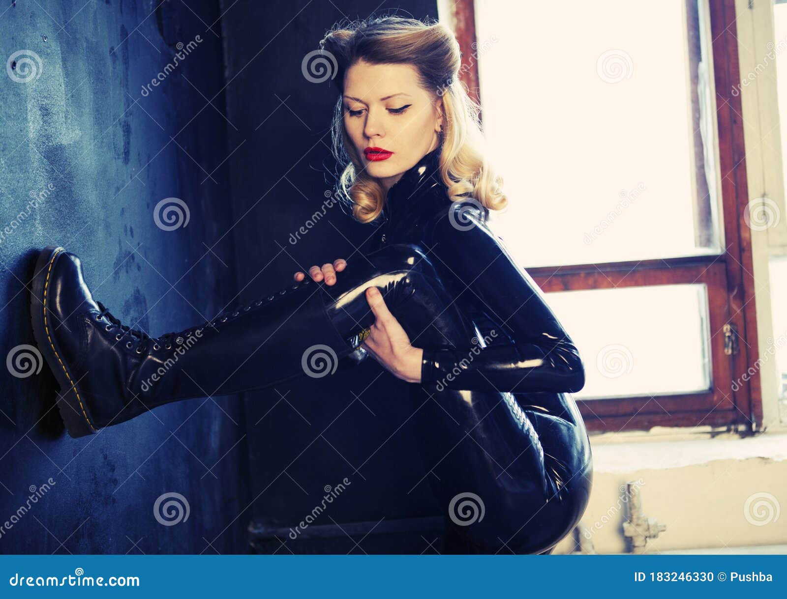 Blonde girl smoking in long latex gloves