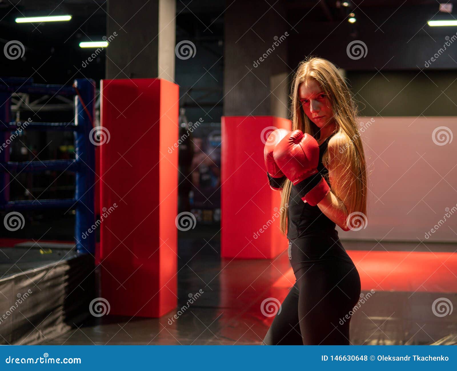 Blonde Caucasian Fighter Girl In Red Boxing Gloves Is Posing In Fight Club Training Hall Stock