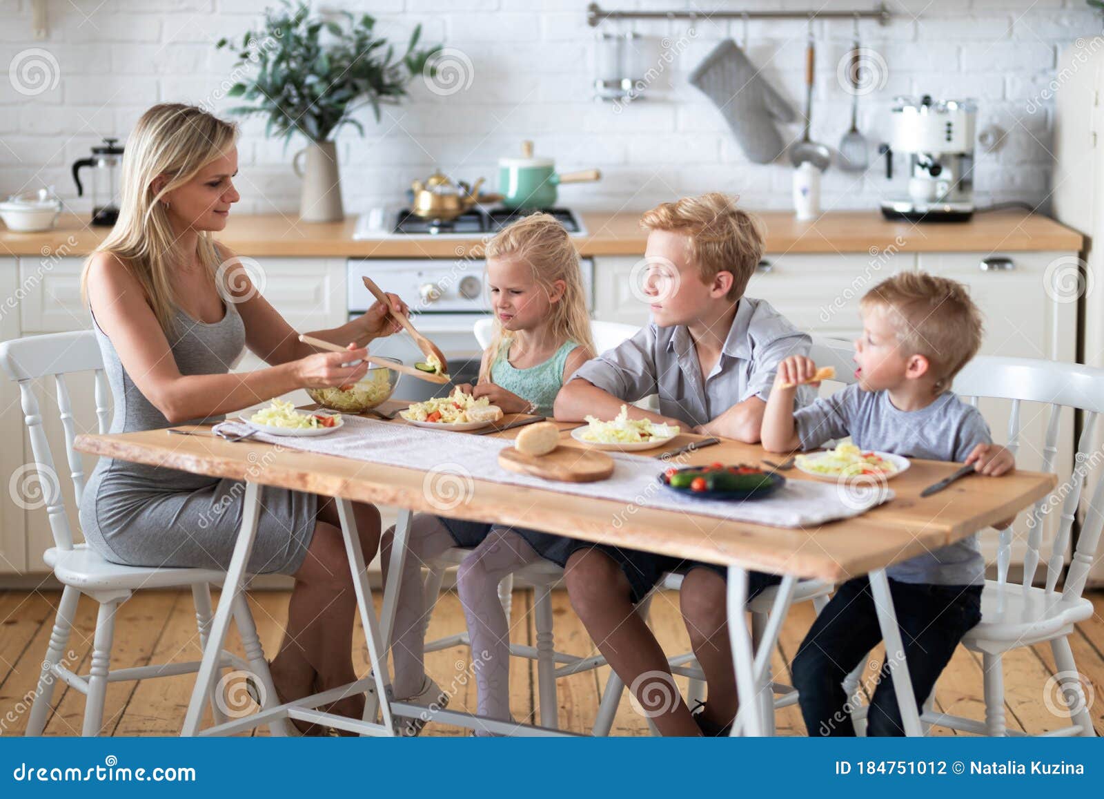 Blonde Family Mother With Three Kids Two Sons And Daughter Eating