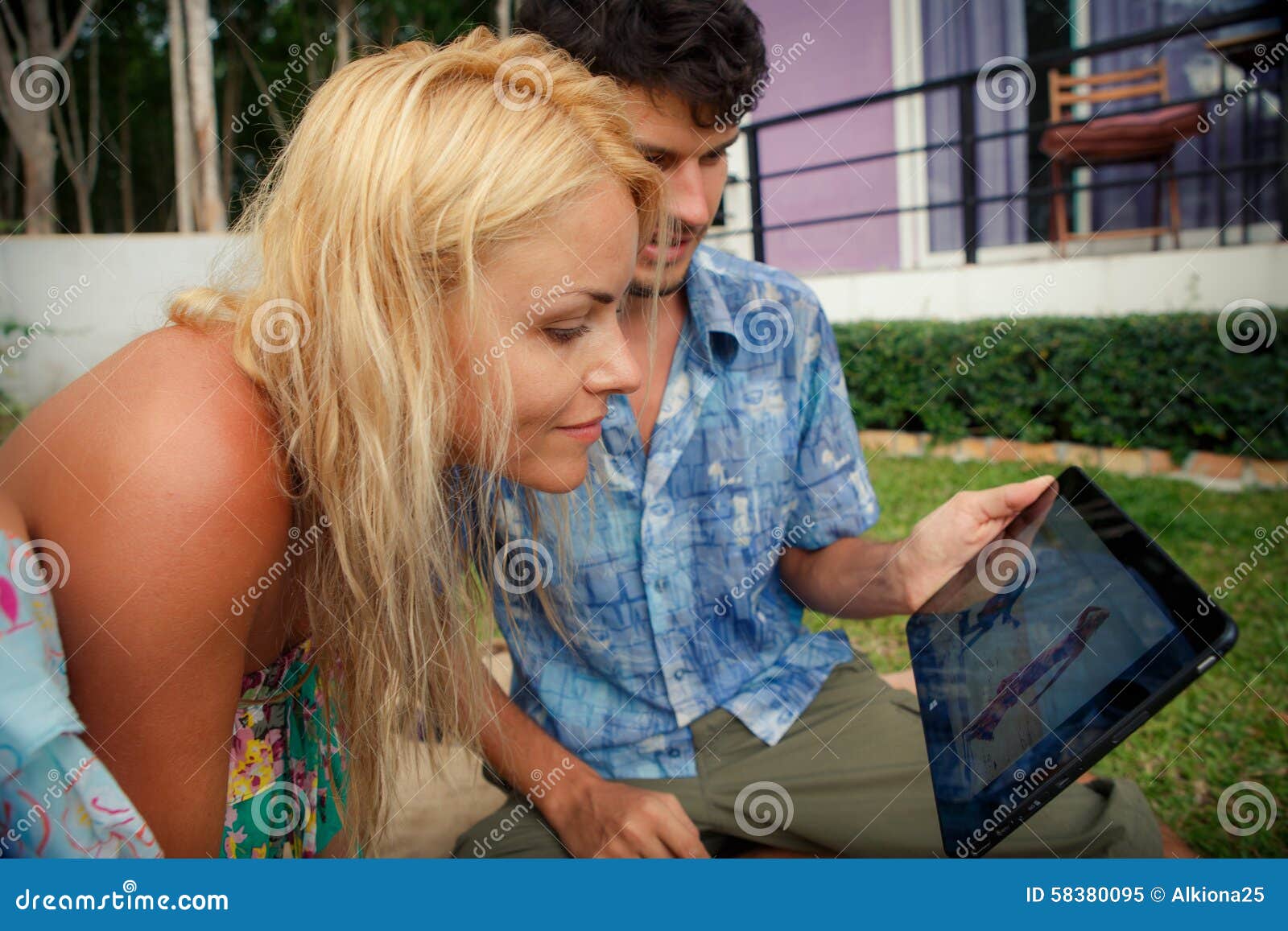 Blonde Girl And Brunette Guy Look Into Ipad Stock Image Image Of 