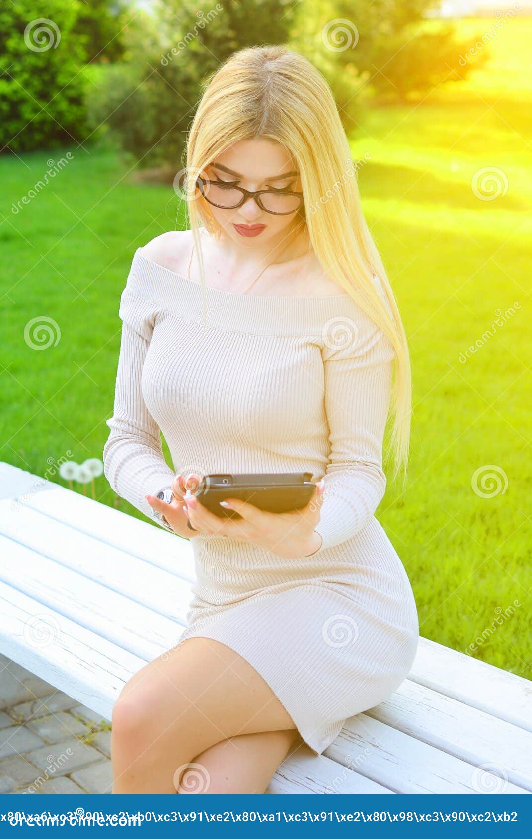 Blonde Girl Enjoys A Smartphone During The Day Outdoors Communication In Social Networks