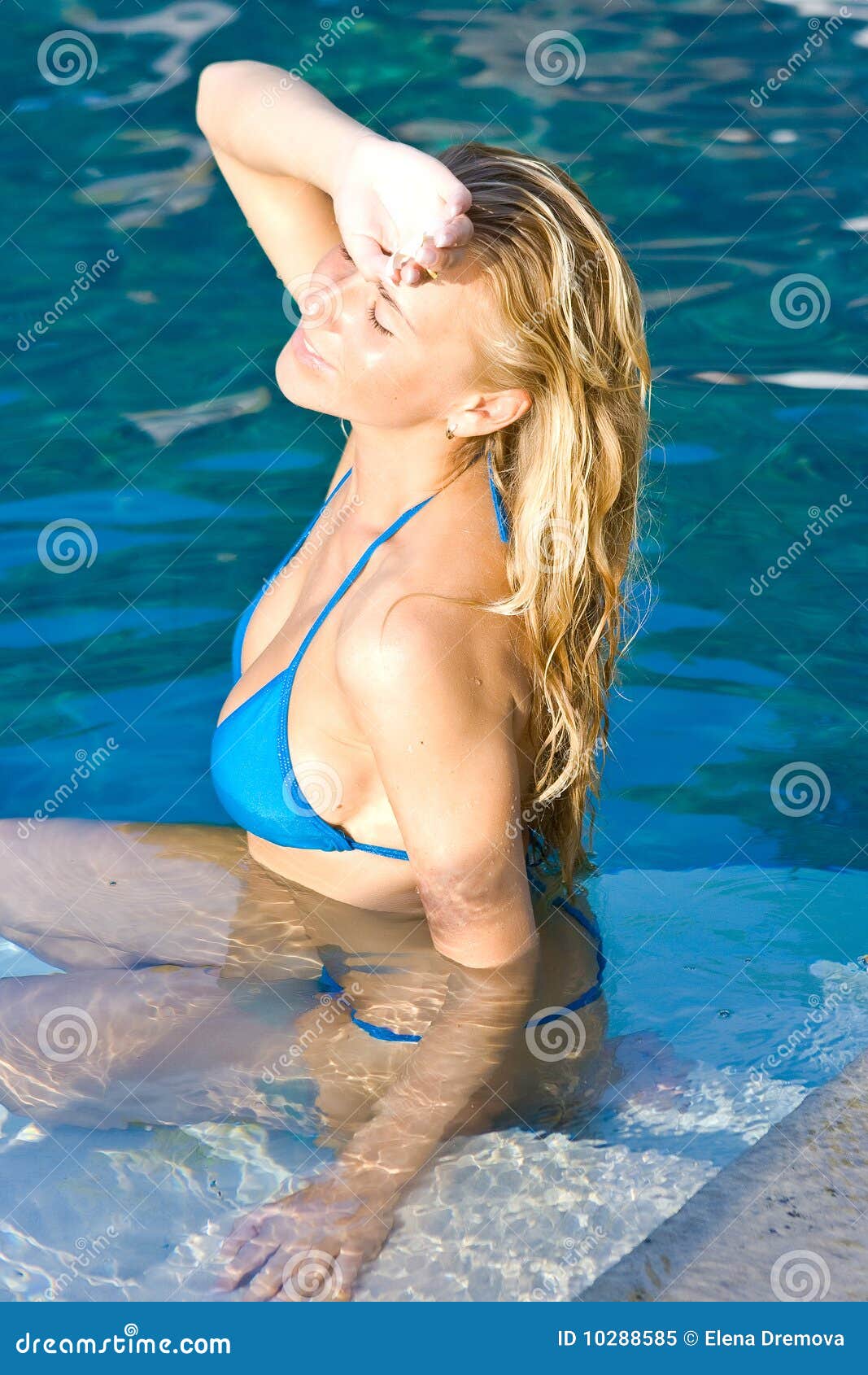 Blonde Girl Relaxing In Water In The Pool Stock Image I