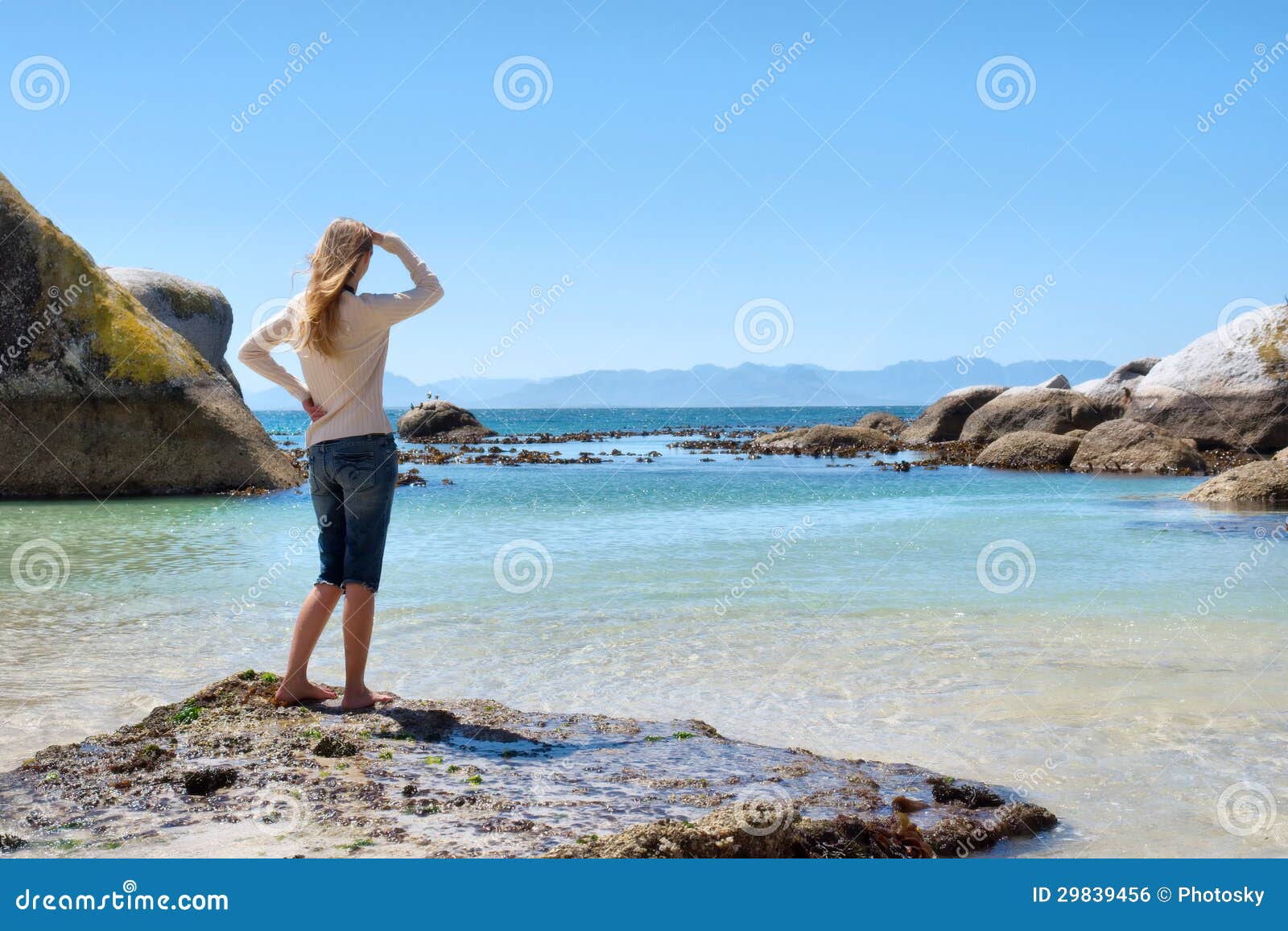 Blonde Girl Stands On Rocky Beach Royalty Free Stock Image 