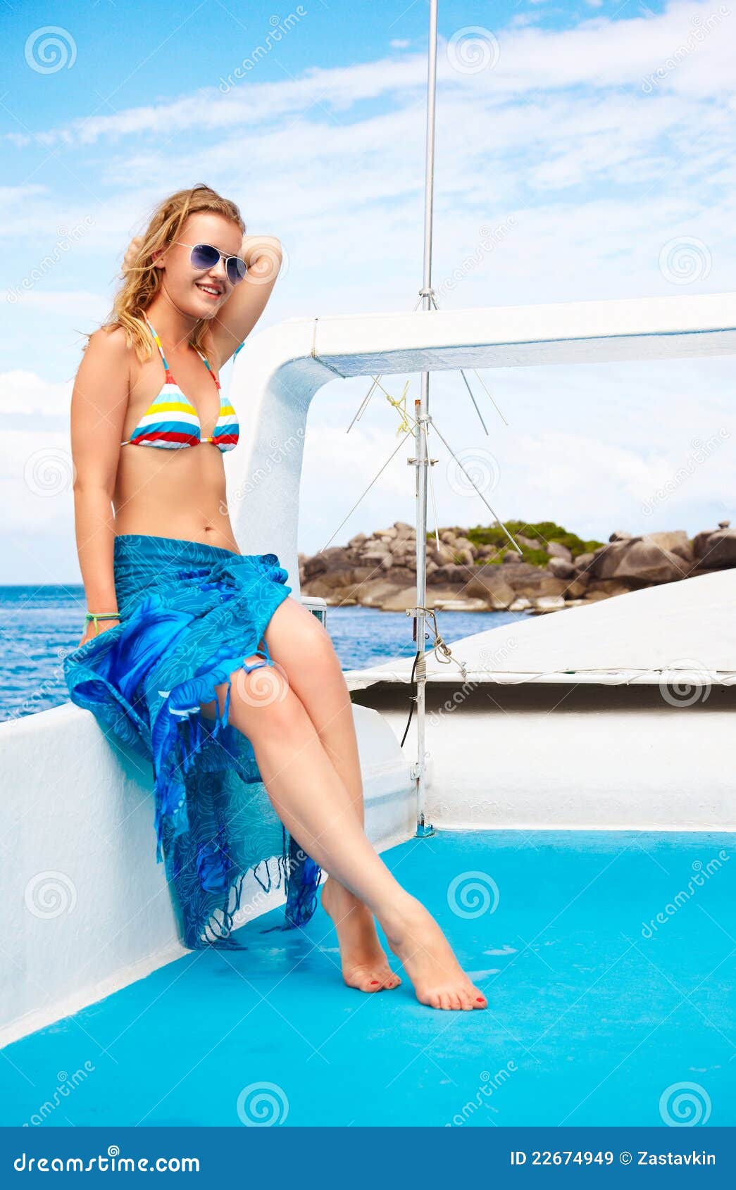 Seductive blond-haired woman with perfect breast and body in fashion bikini  inside the crystal clear sea posing for the camera. Summer beach vacation.  Phuket. Thailand Stock Photo
