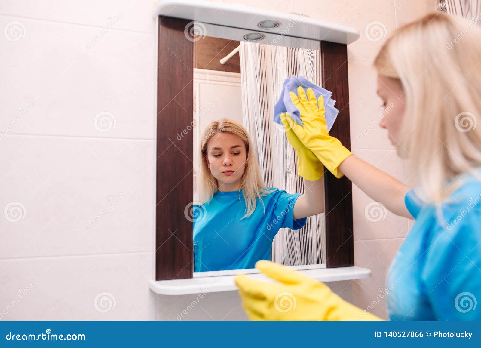 Blonde Girl In Yellow Gloves Cleaning With Spray Mirror At