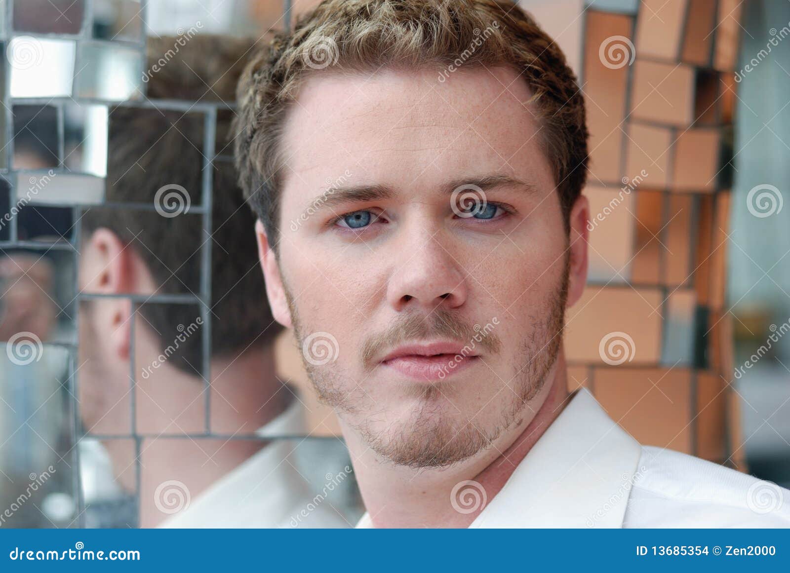 blonde african american man with blue eyes looking at camera