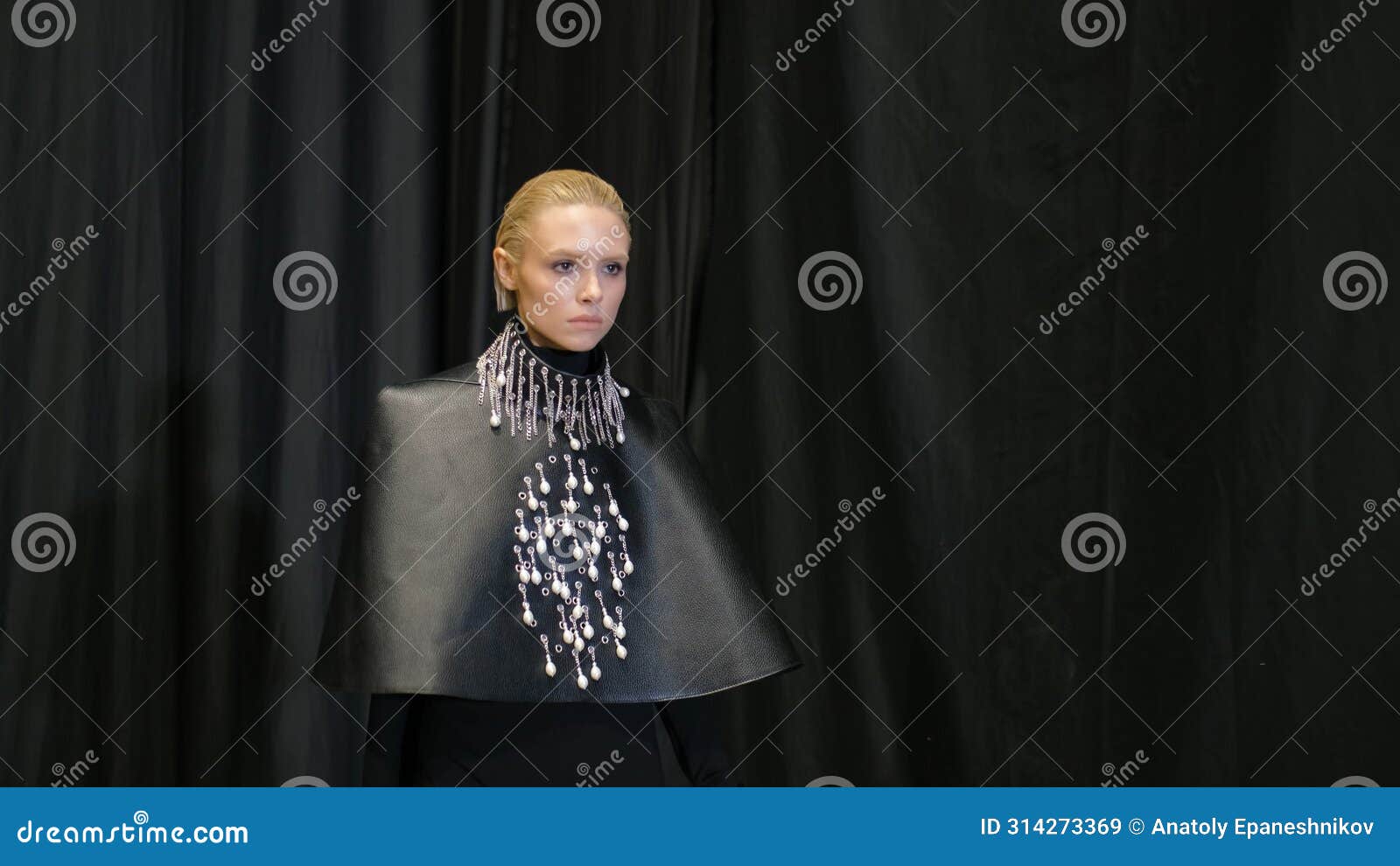 blonde hair model girl moving on catwalk podium. female fashion runway defile.