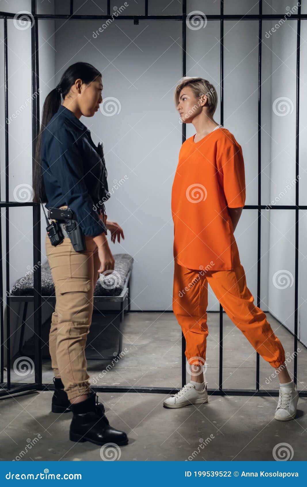 Blonde Inmate In An Asian Women`s General Security Prison Is Led Out Of Her Cell By A Uniformed