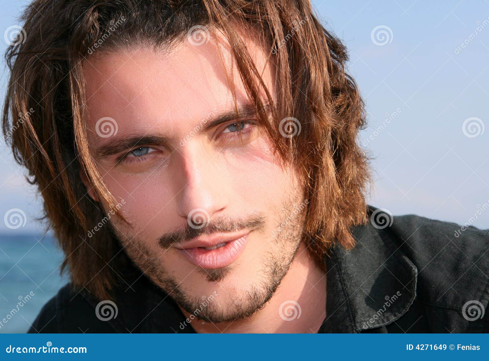 blonde african american man with blue eyes looking at camera