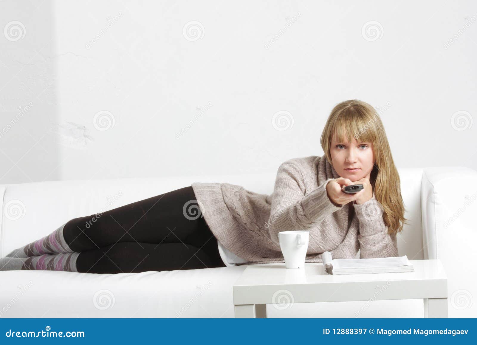 Blonde with remote control stock image. Image of woman - 12888397