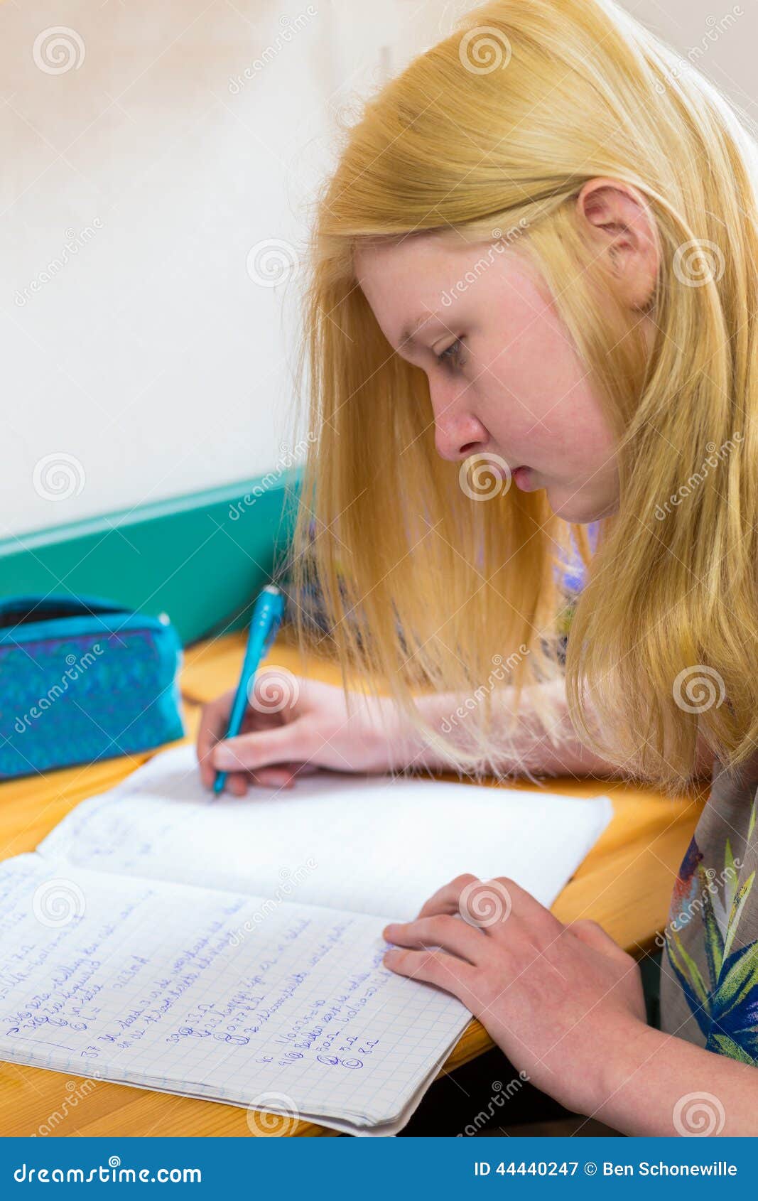 blonde schoolgirl making homework