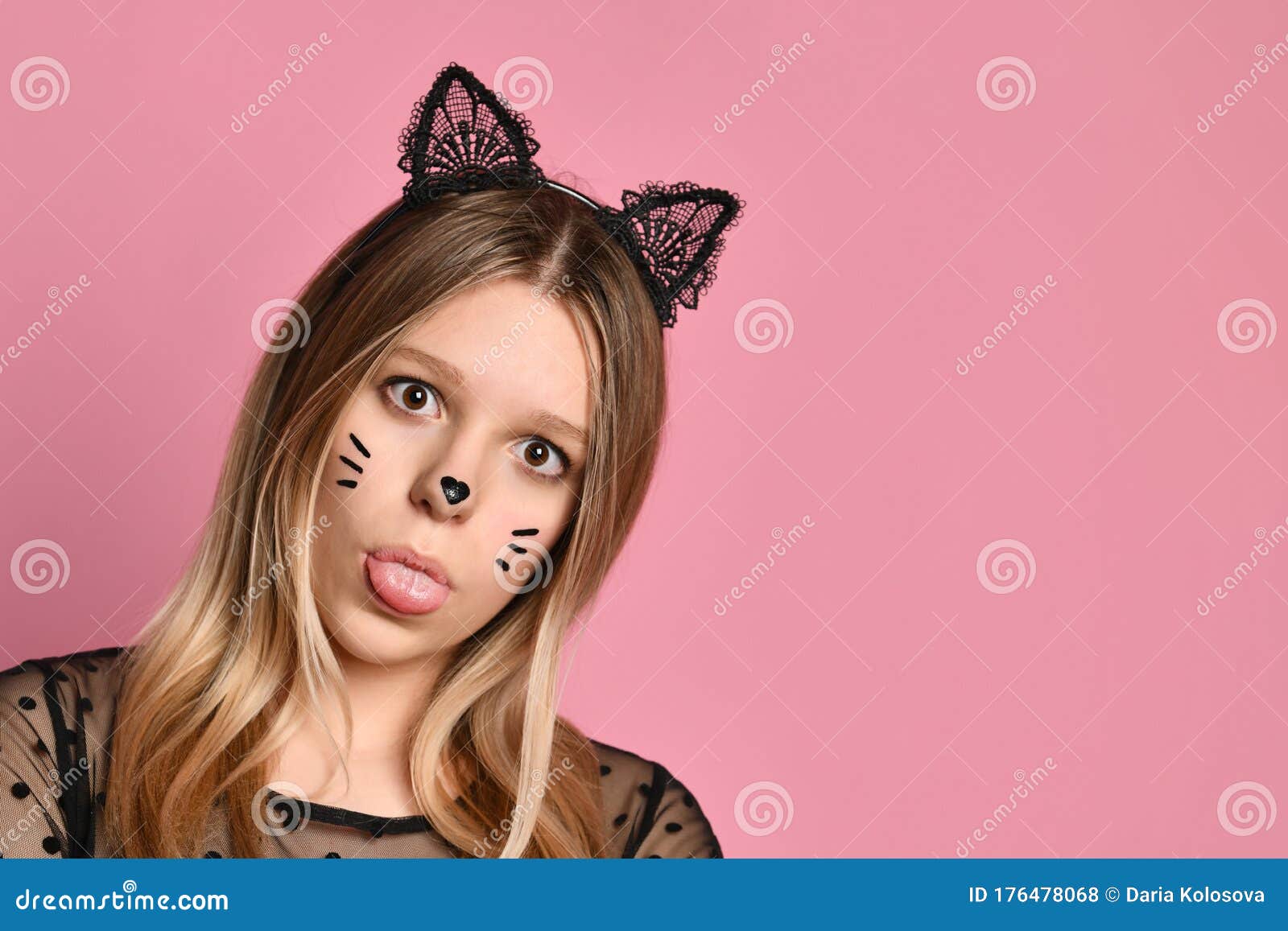 Blonde Teenager in Black Dress, Headband Like Cat Ears, Face Painting. she  Showing Her Tongue, Posing on Pink Background. Close Up Stock Photo - Image  of headband, clothes: 176478068