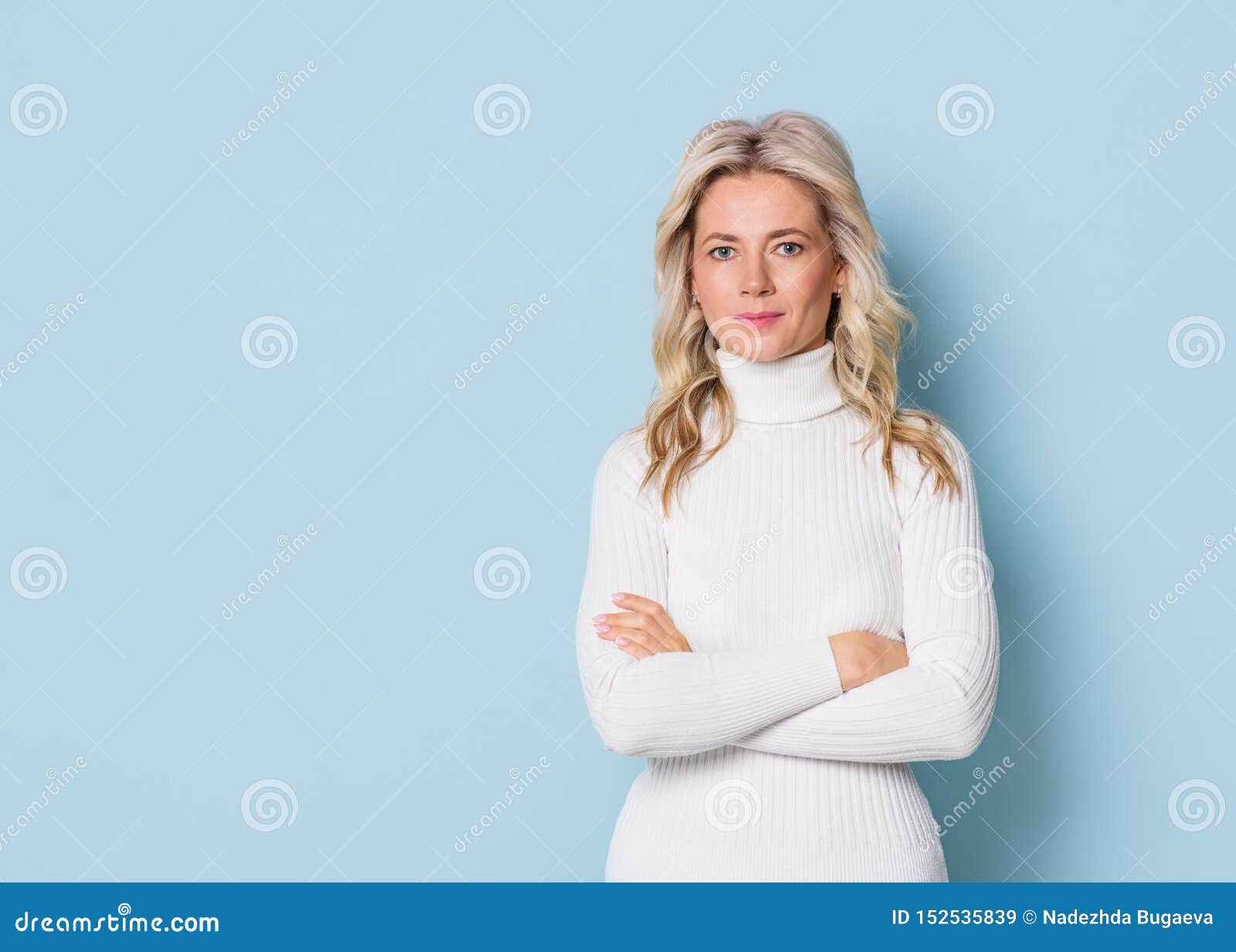 blonde woman adult attractive beautiful portrait en face, cauasian and scandinavian girl on blue background