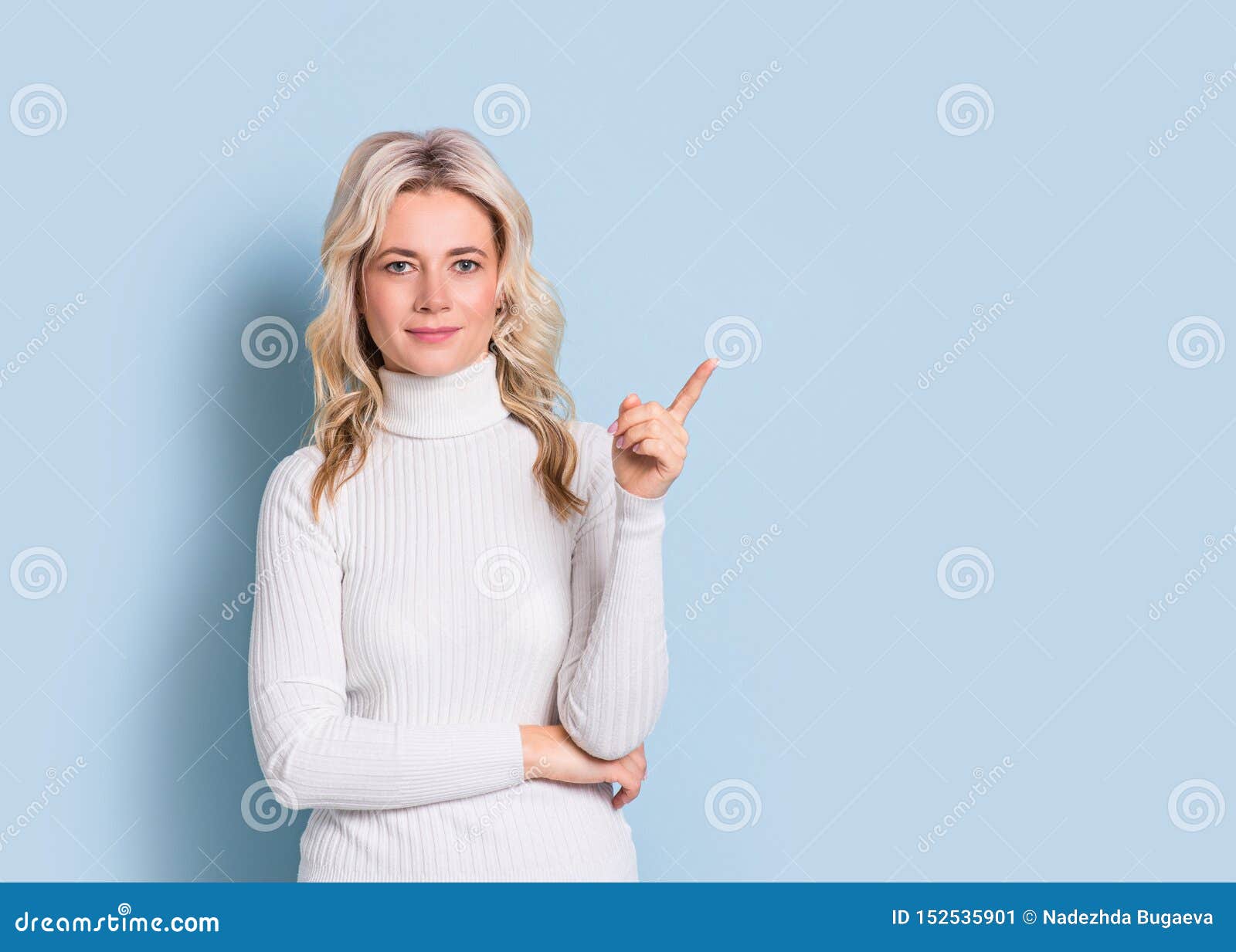 blonde woman adult attractive beautiful portrait, point and show, cauasian and scandinavian girl on blue background