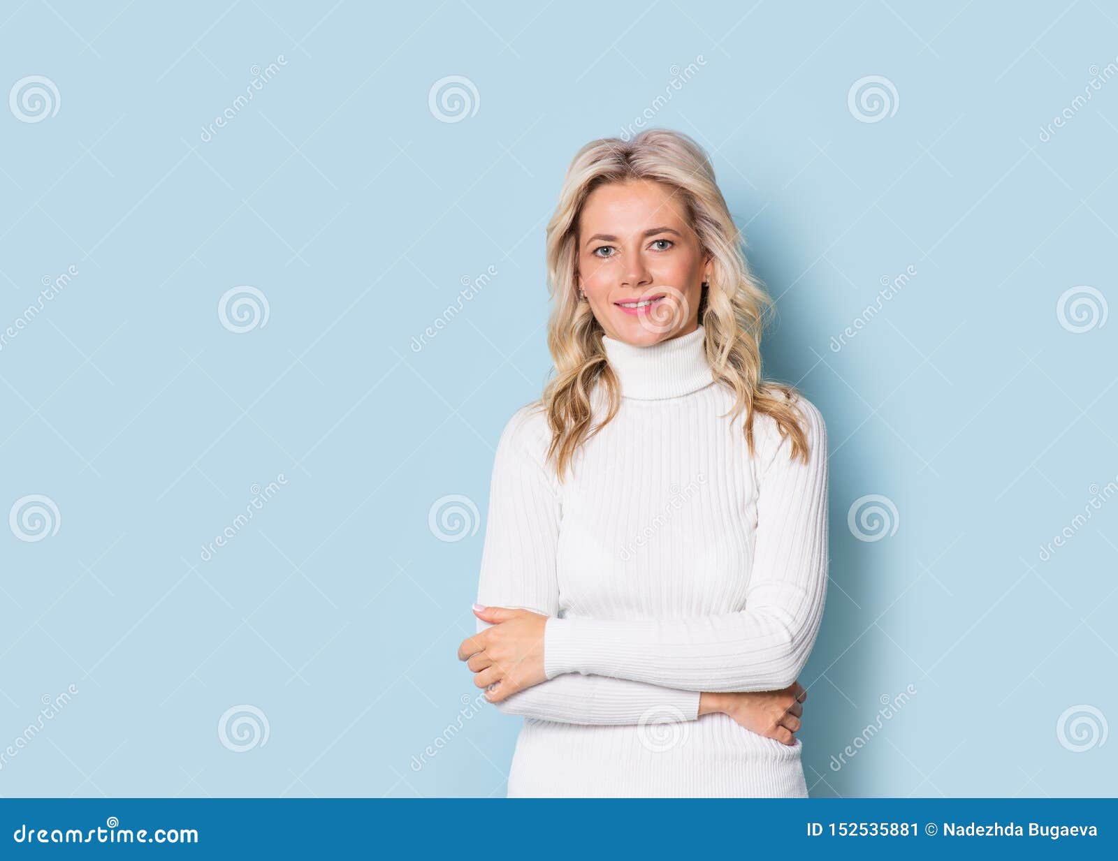 blonde woman adult attractive beautiful smiling portrait en face, cauasian and scandinavian girl on blue background