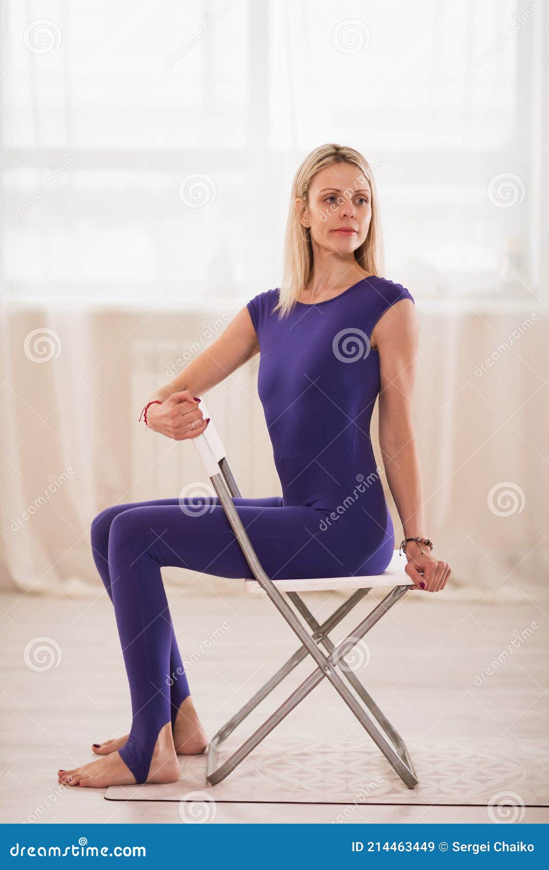 A 20-year-old female trainer practices Pilates on an elevator