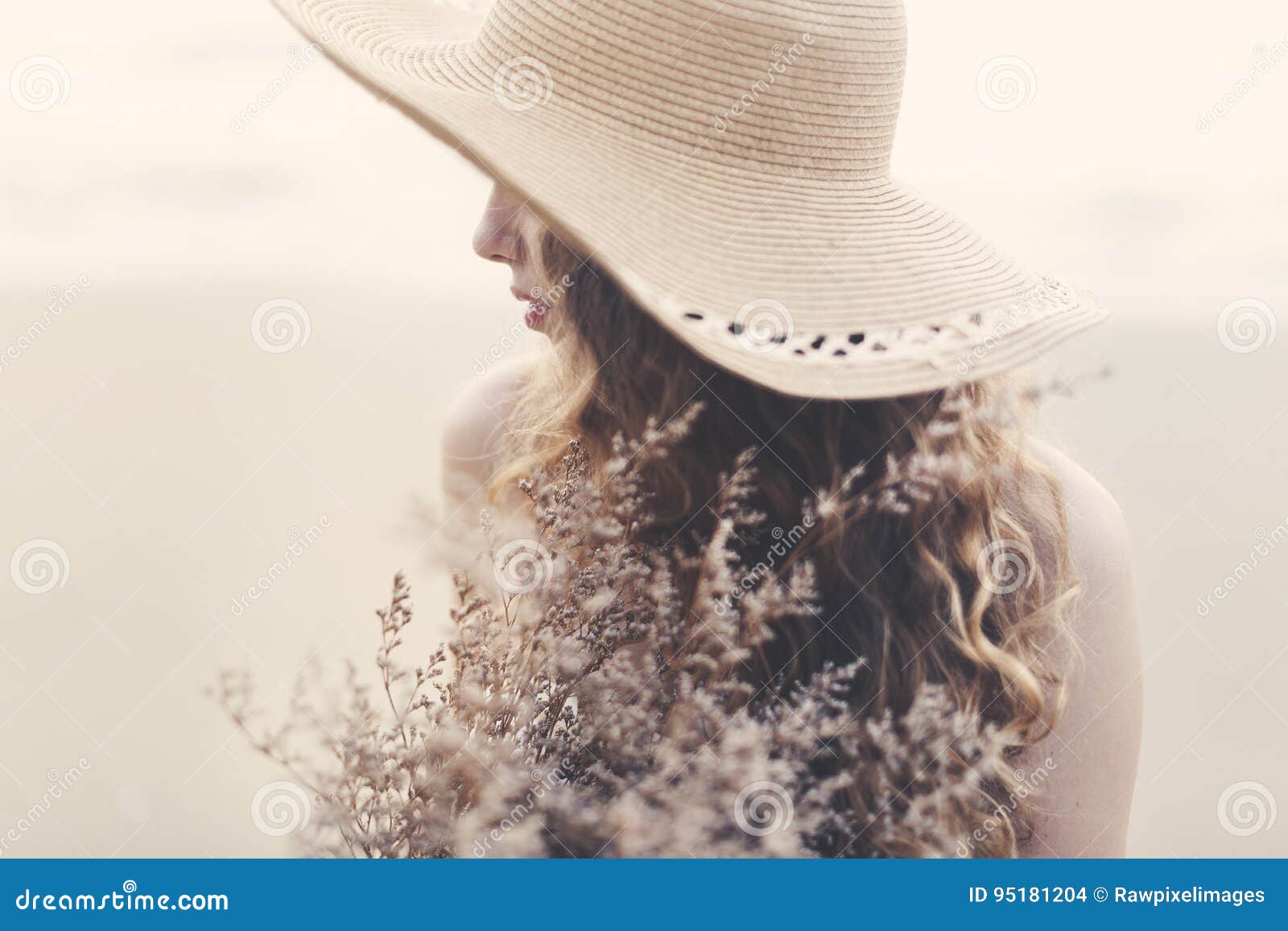 A Blonde Woman Holding a Flower Outdoors Stock Photo - Image of ...