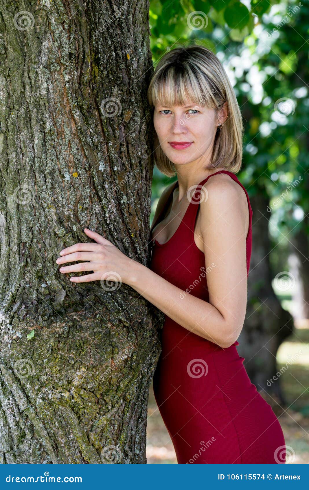 Blonde Woman Hugging a Tree in Park. Young Girl in a Red Dress Resting ...