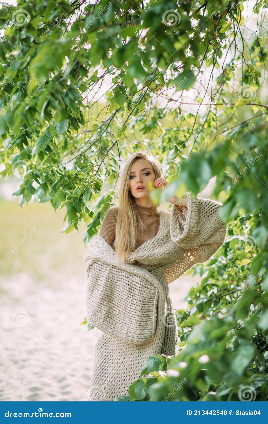 Blonde Woman Poses among Green Branches of Tree Near Lake Stock Photo ...