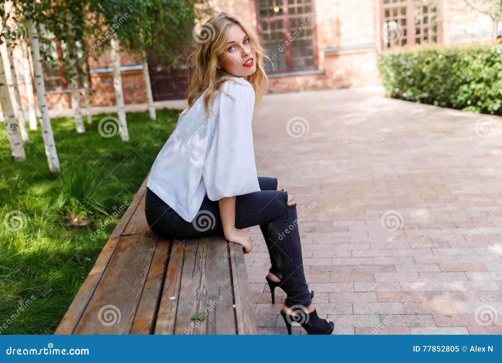 Blonde Woman in Ripped Jeans Sitting on Park Bench Stock Image - Image ...