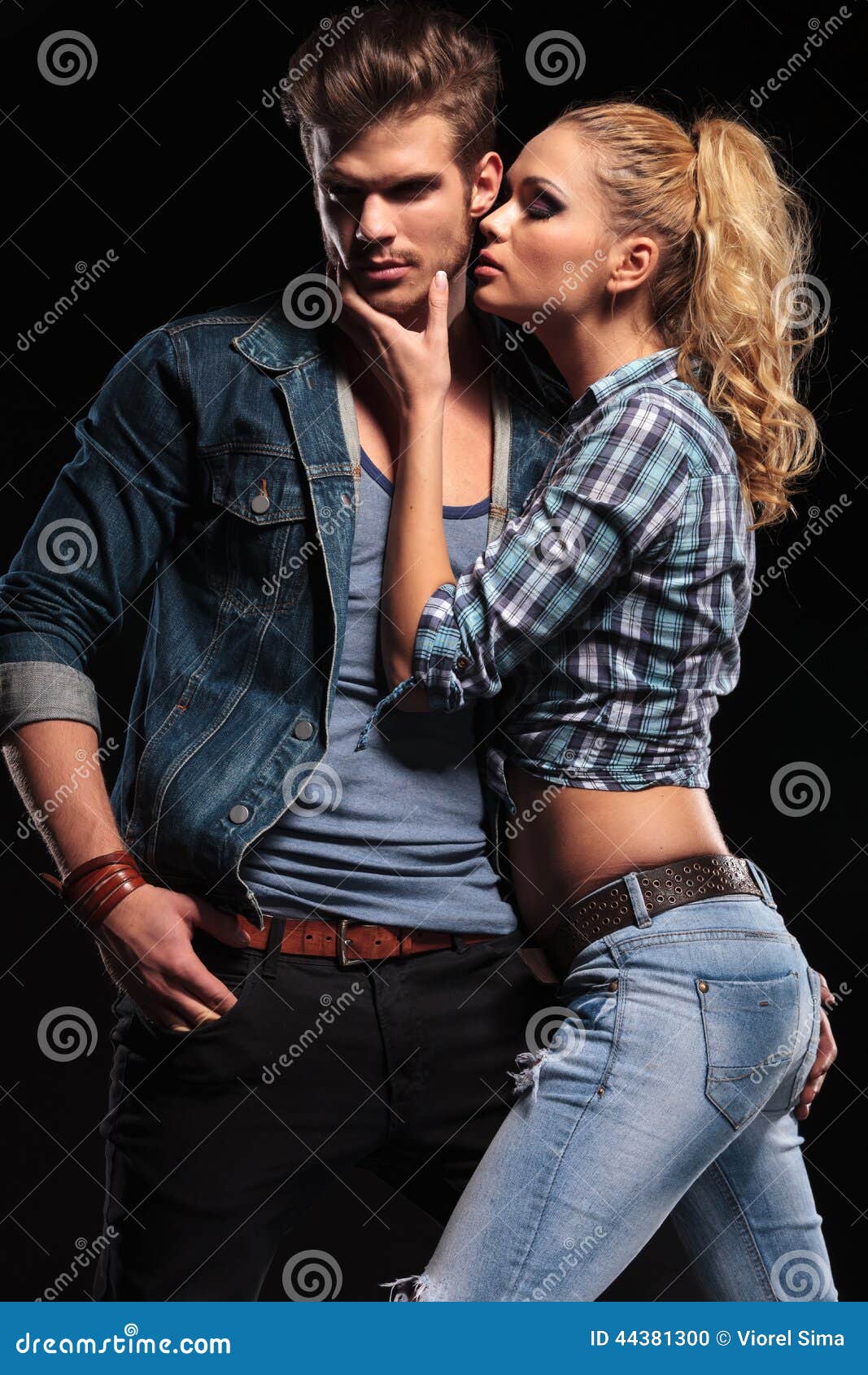 Blonde Woman Trying To Kiss Her Boyfriend on the Cheek Stock Photo