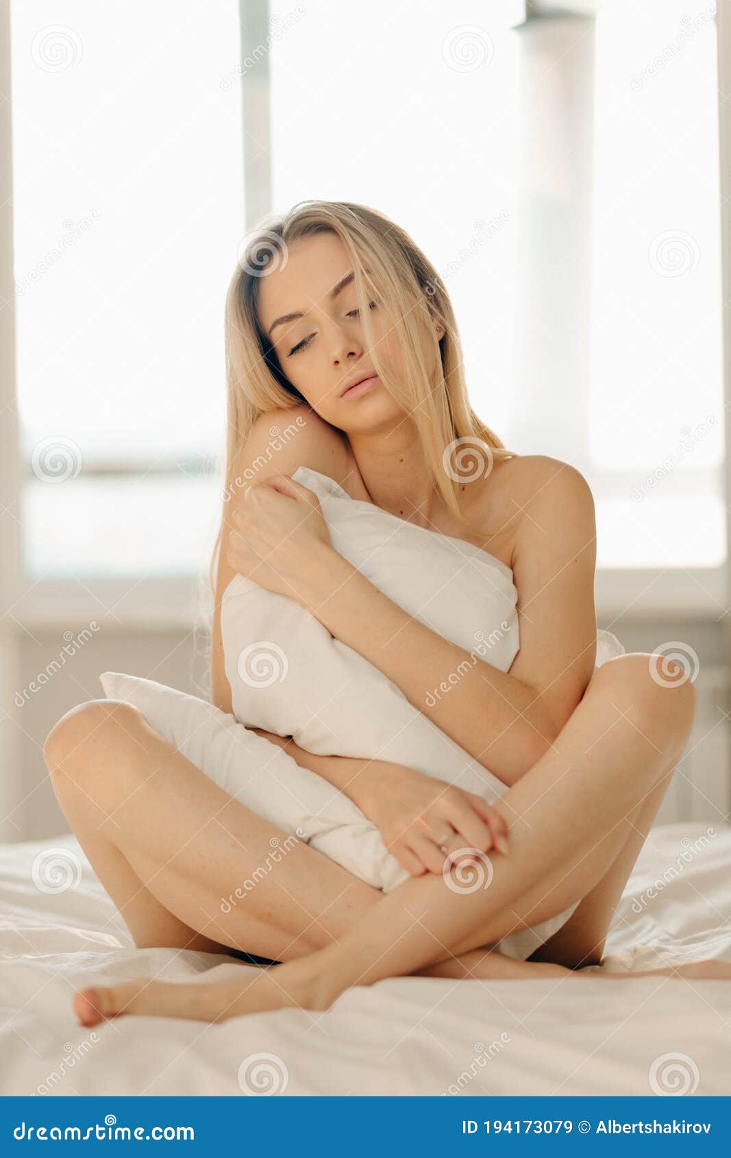 https://thumbs.dreamstime.com/z/blonde-young-woman-basksing-bed-sleeping-hugging-her-pillow-closing-her-eyes-sitting-naked-crossed-legs-194173079.jpg