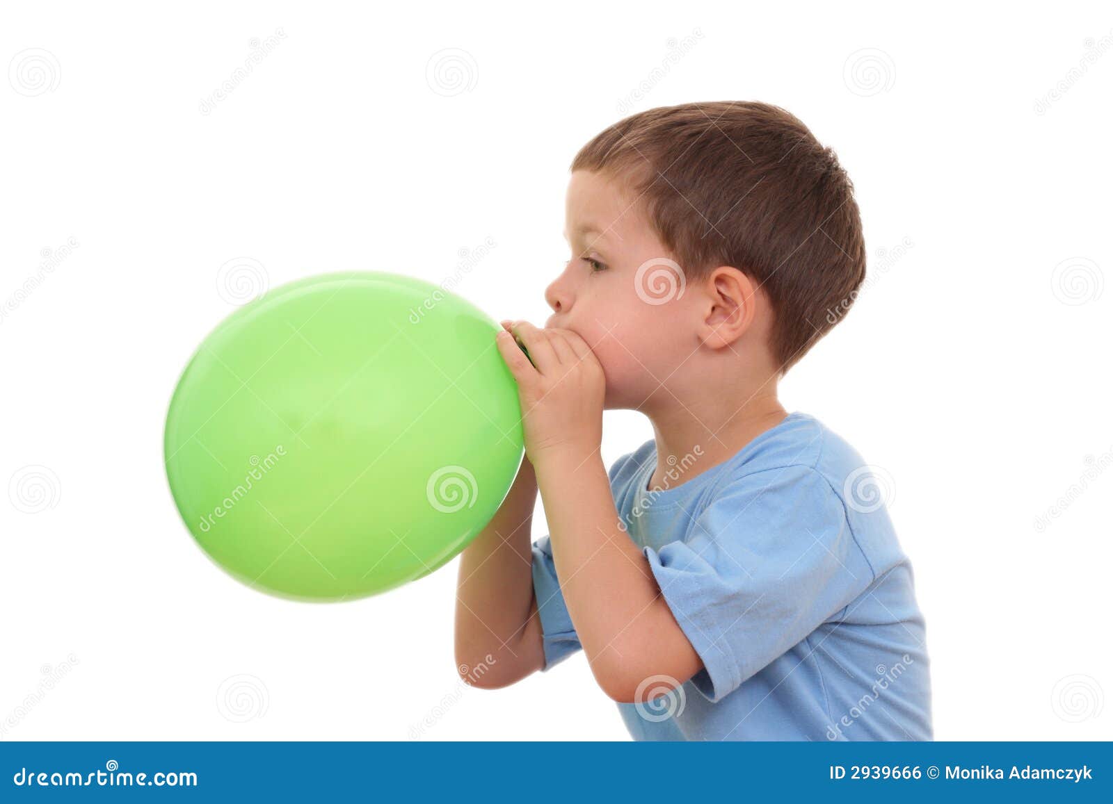 Boy blowing balloon from plastic car bottle at home stock photo
