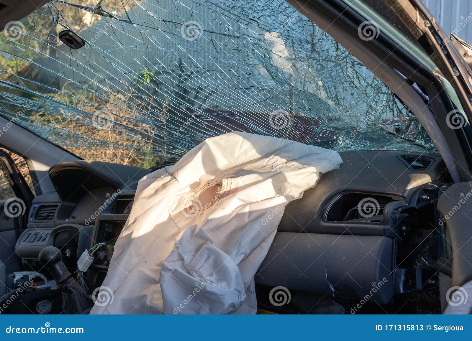 Blown Up Airbag after a Car Crash and Broken Glass. Problems Drinking