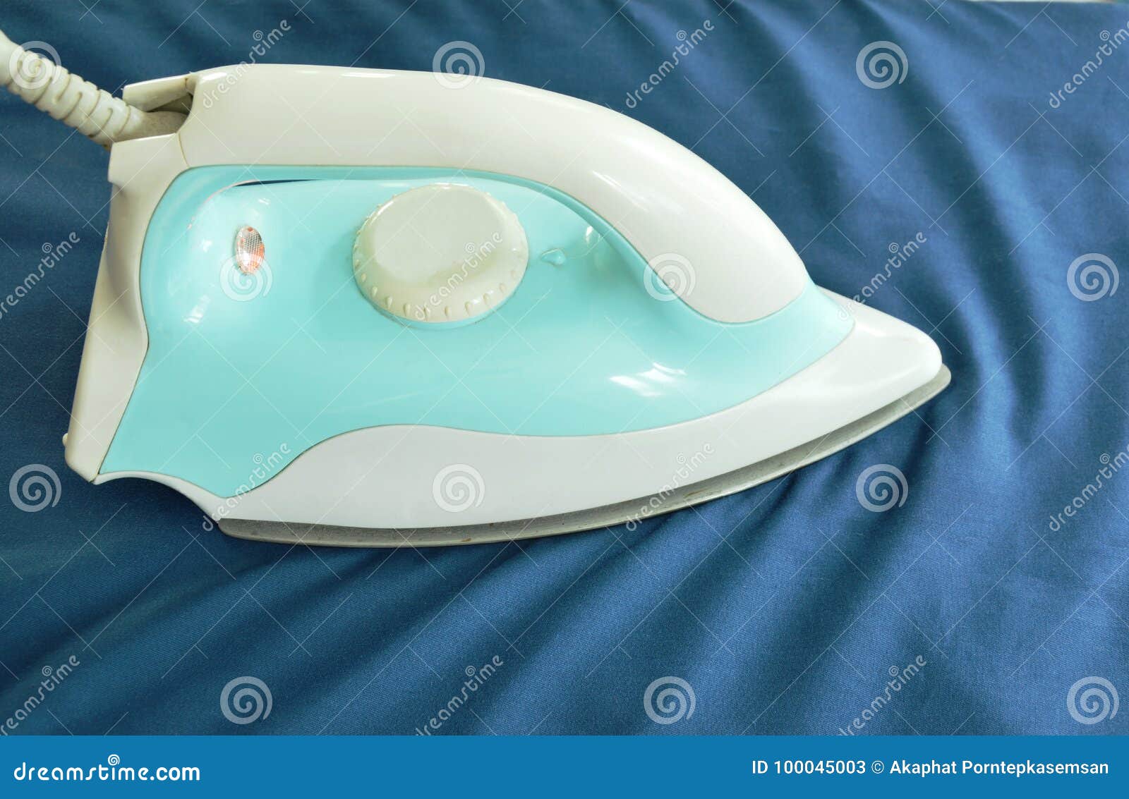 Automatic Electric Iron Pressing Shirt on Ironing Board Stock Image
