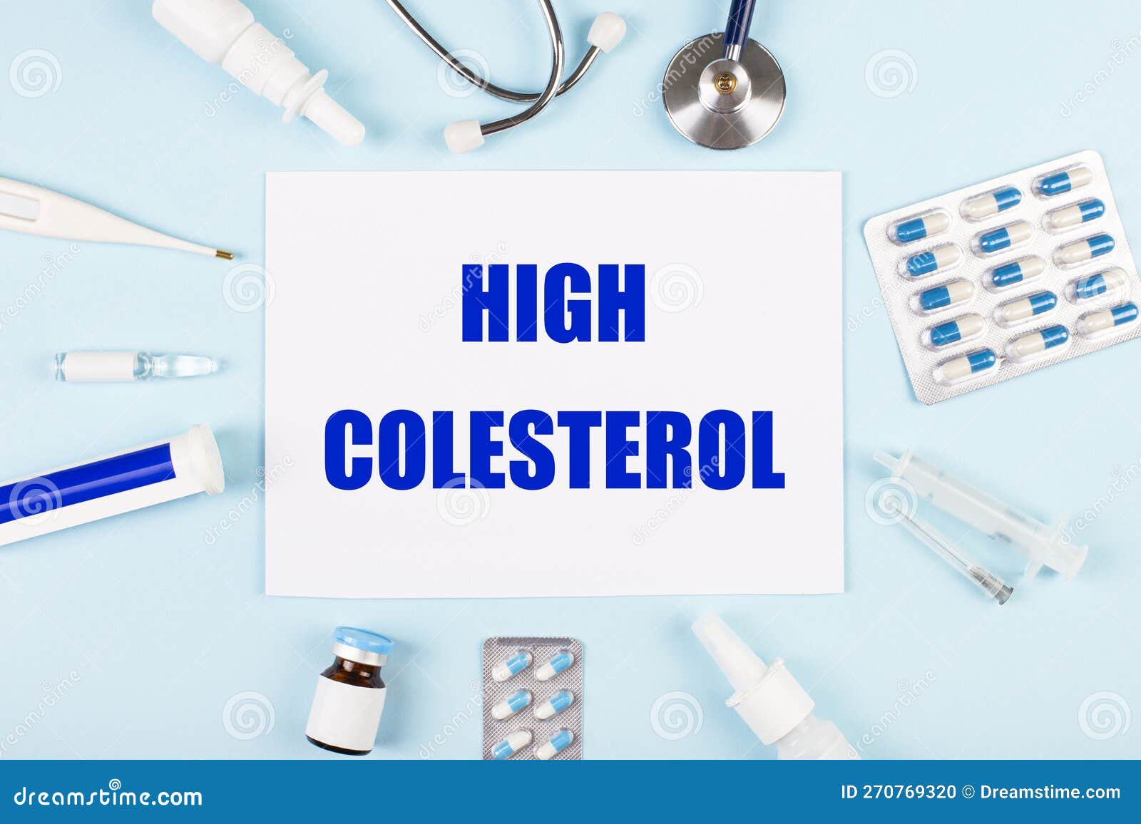 on a blue background, a stethoscope, a thermometer, pills, medicine bottles and a piece of paper with the text high colesterol