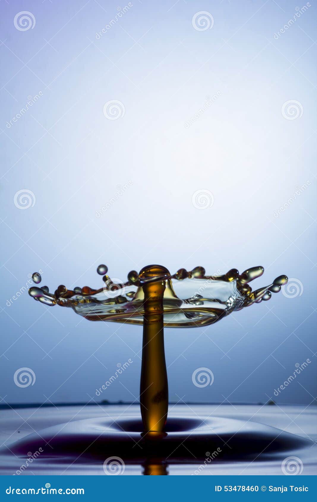 blue background. water drops falling into each other and breaking.