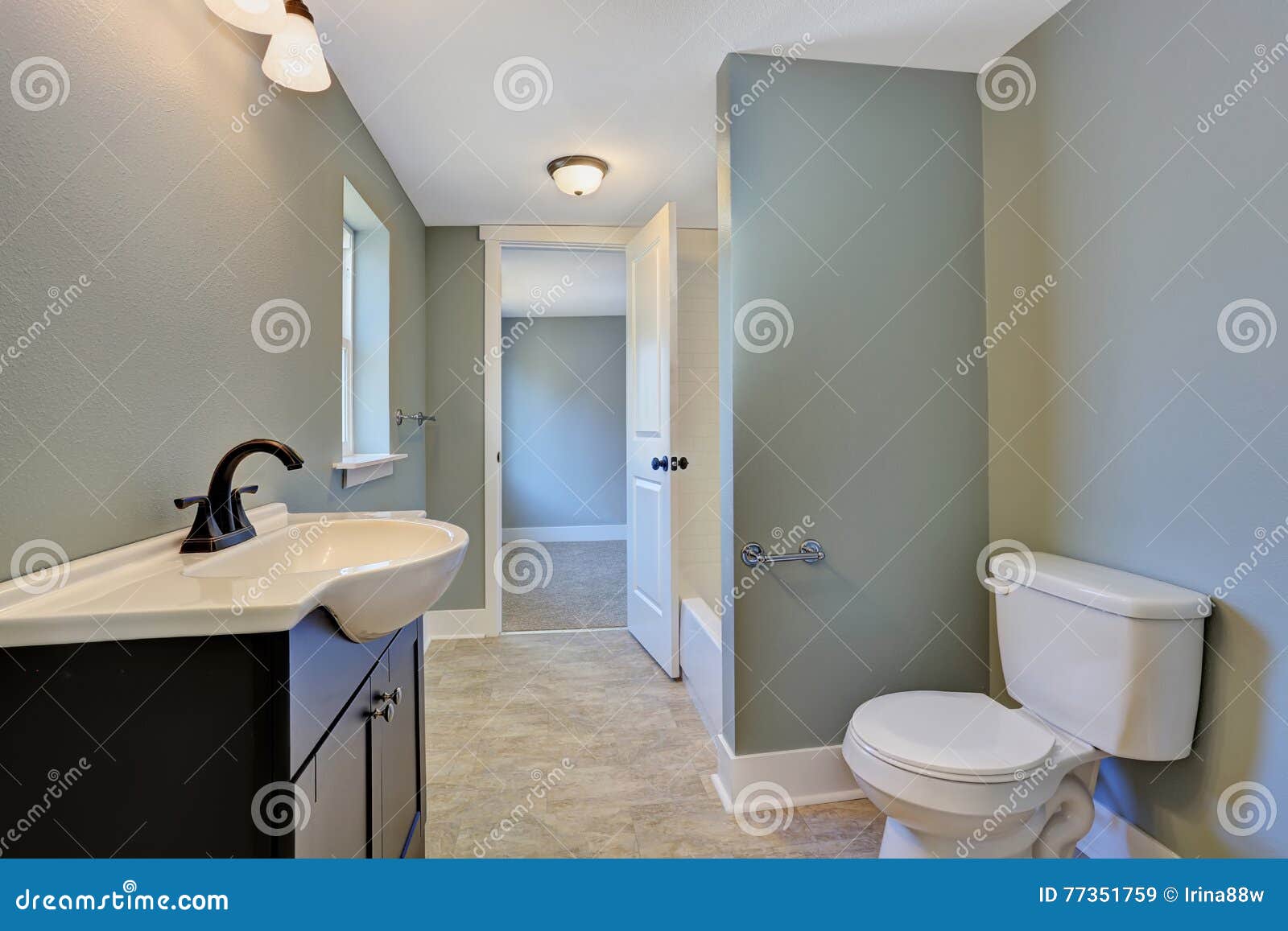 Blue Bathroom Interior With Black Vanity Cabinet Toilet And Tile