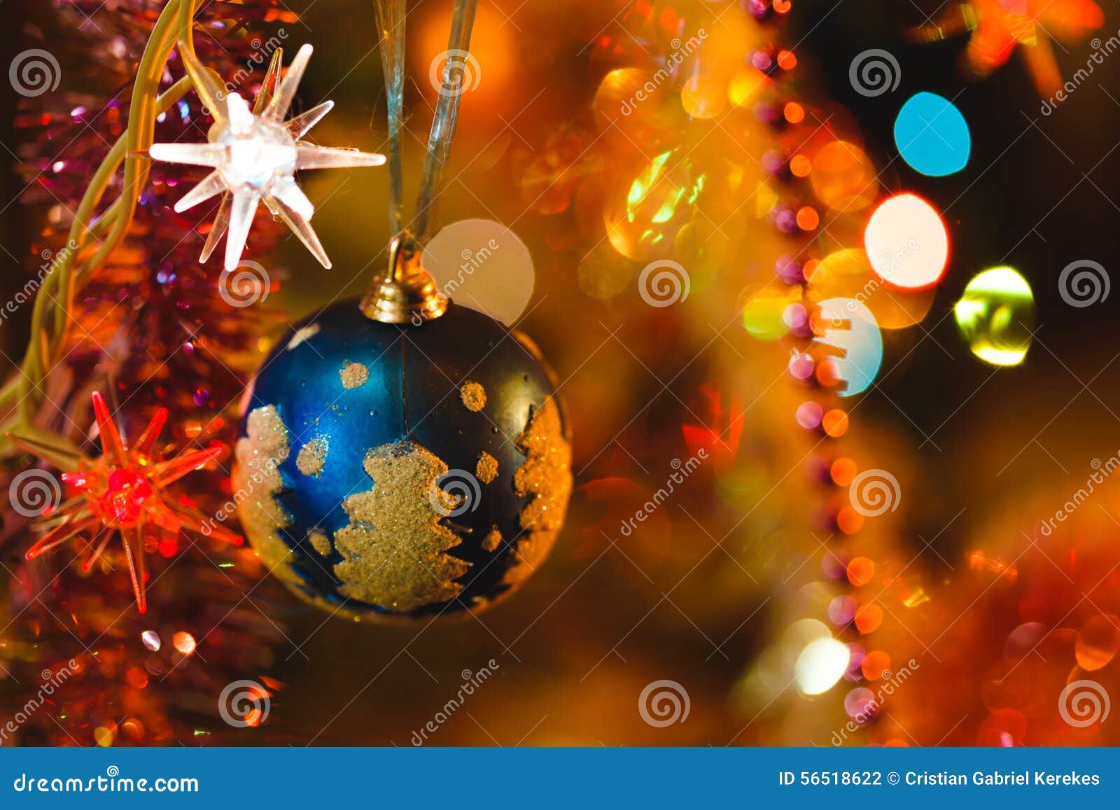 Blue Bauble in Christmas Tree Surrounded by Colourful Lights Stock ...