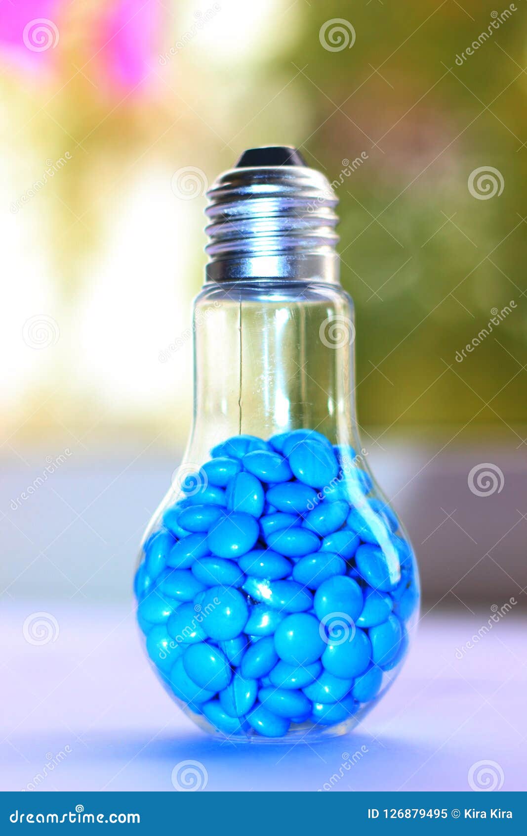Blue Candy in a Glass Lamp in the Form of a Light Bulb, Concept Stock
