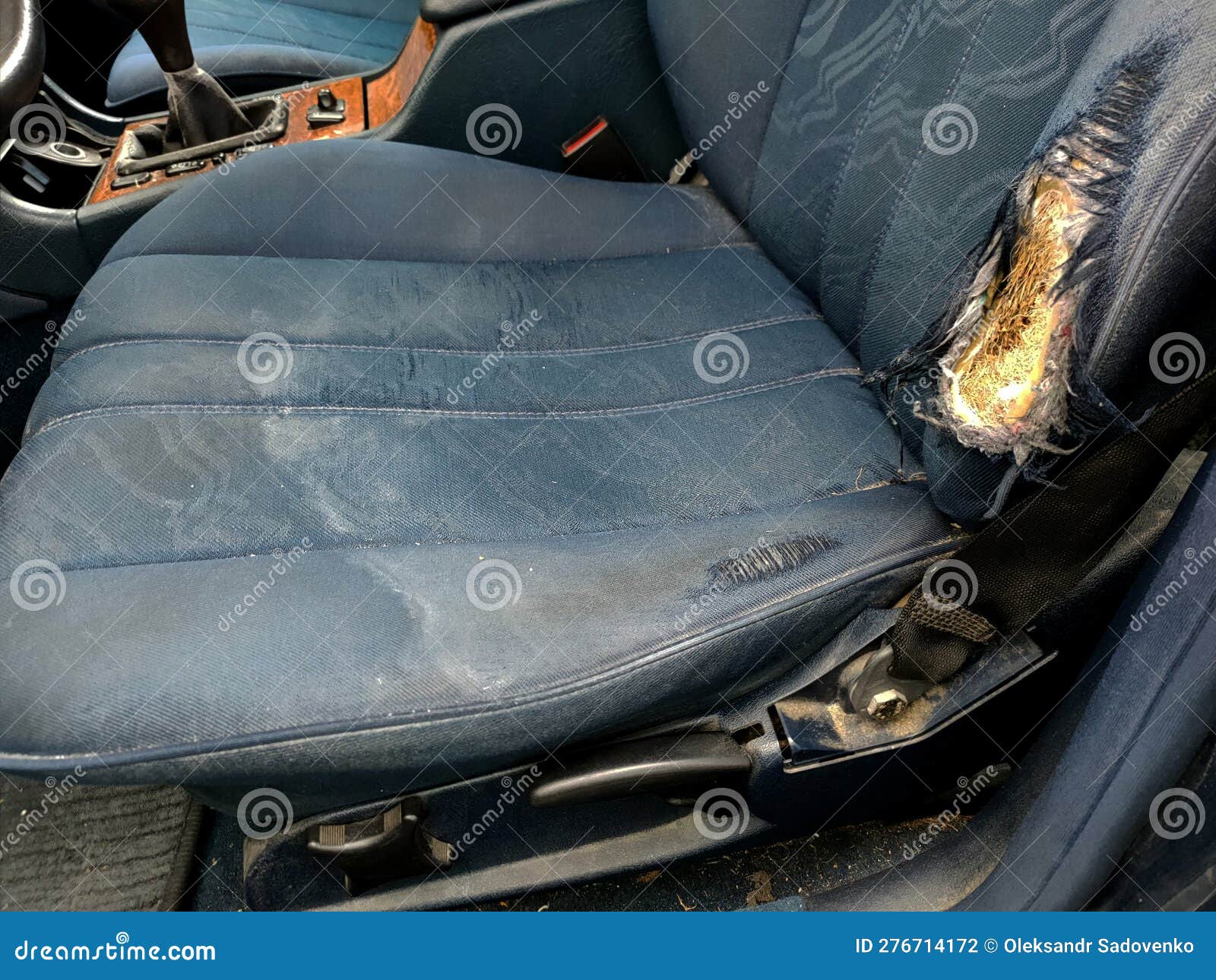 blue car seat with torn upholstery
